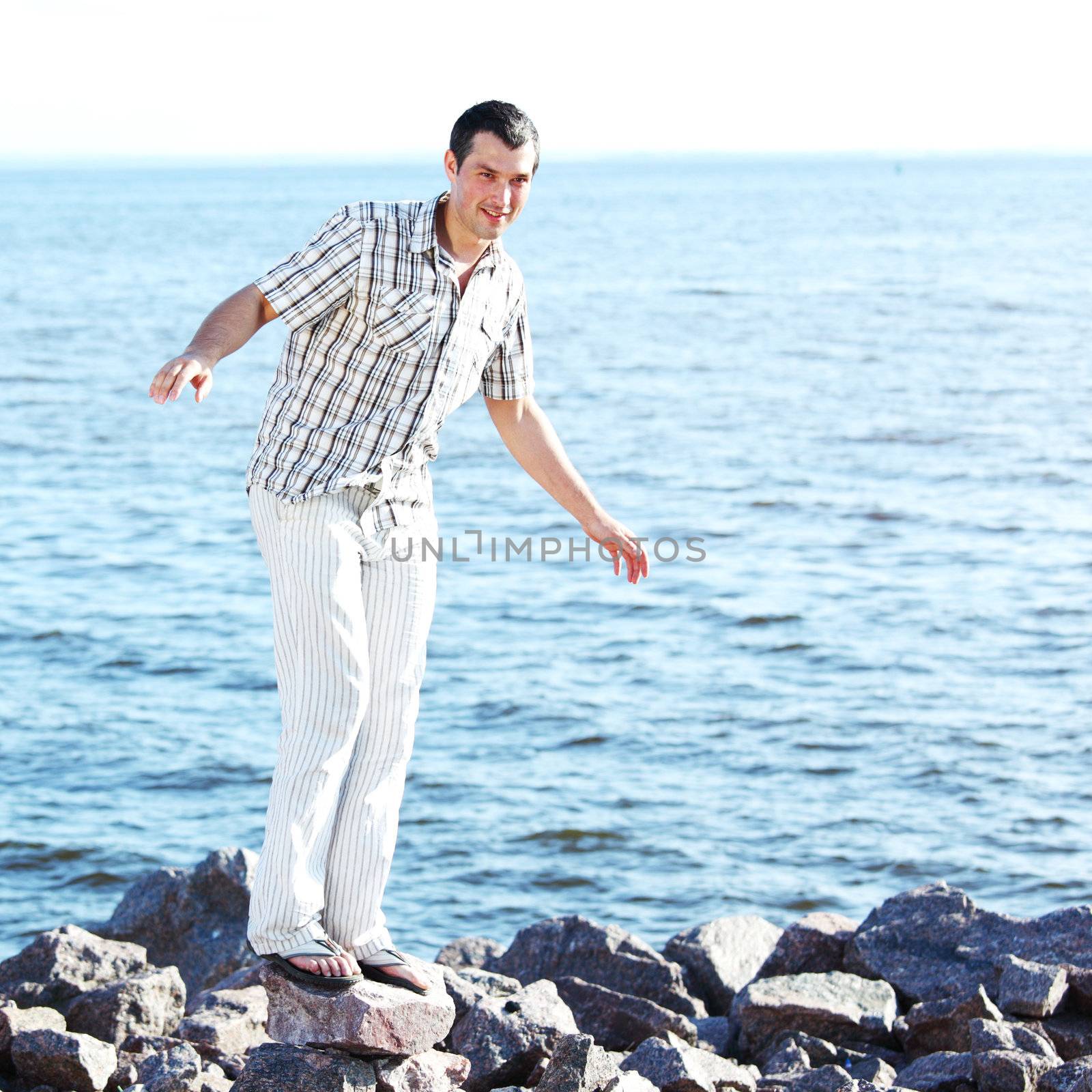 man stay on ground sea on background