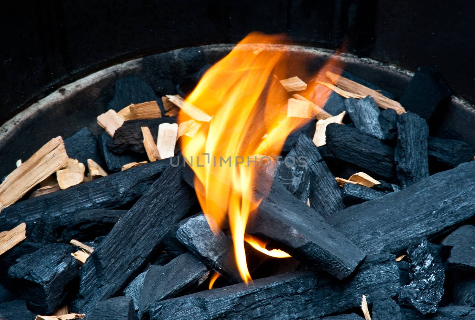 Flame and charcoal in a bbq grill