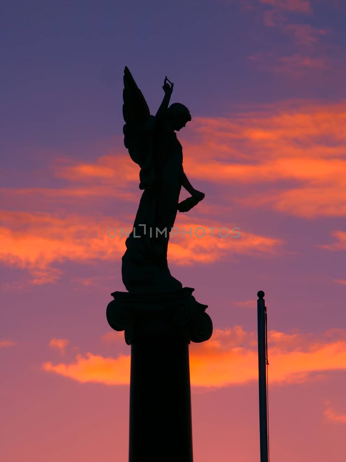 Warrnambool, Australia - August 16, 2005: The Warrnambool War Memorial commemorates Australian veterans who served their country.  Seen here is the angel on the top part of the monument silhouetted against the sunset.