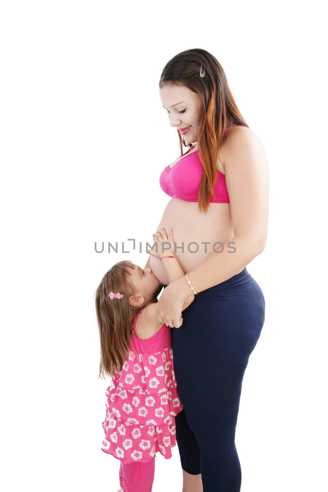 Nice Caucasian woman pregnant with her daughter on the background