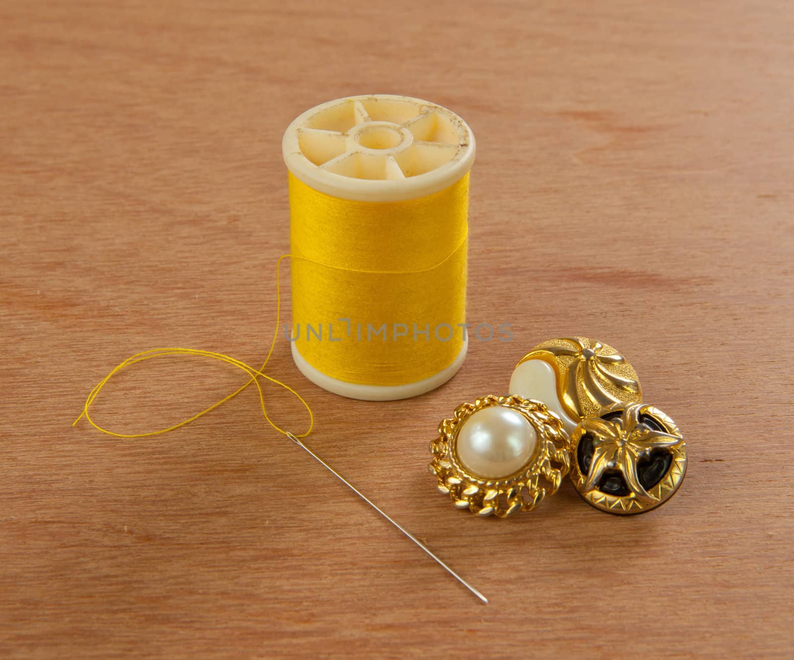 yellow thread on wood background