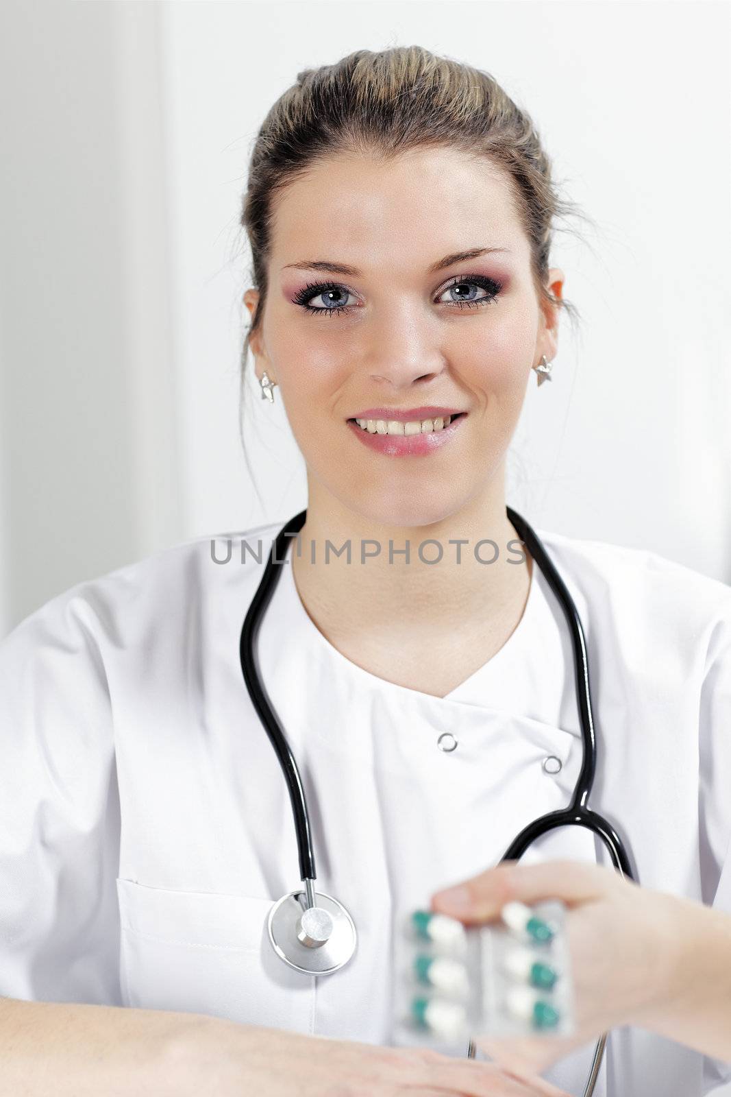 woman doctor with pills and stethoscope in hospital