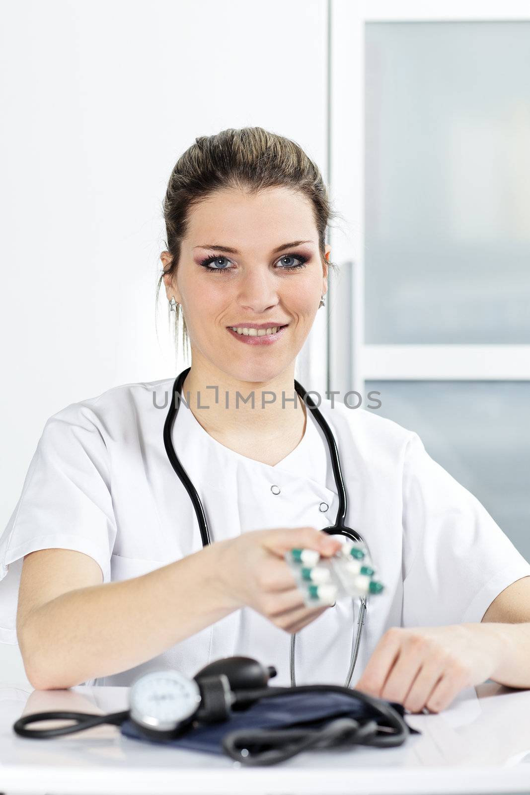 woman doctor in hospital with pills in the hand