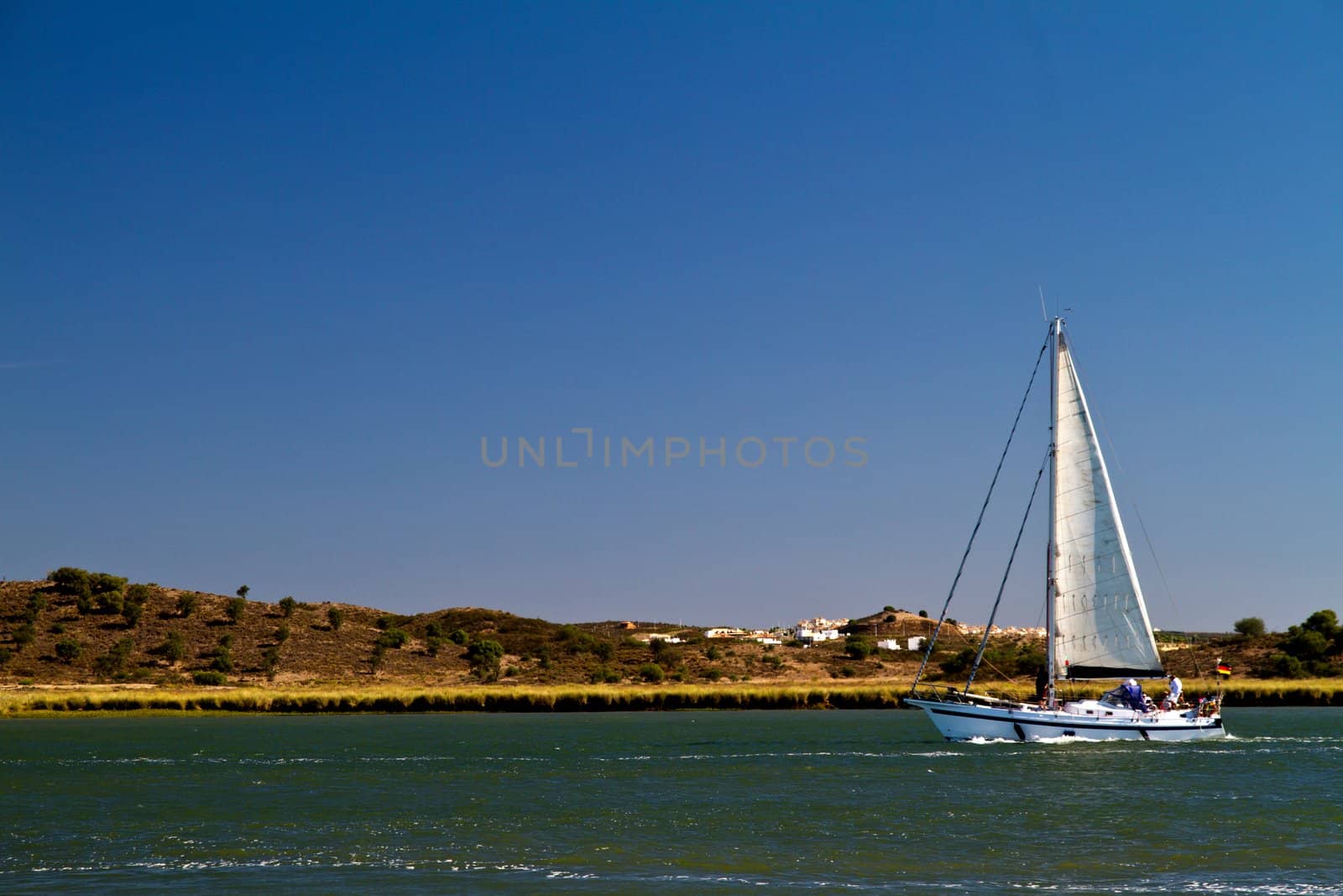 View of a sailboat in the Guadiana river in the Algarve, Portugal.