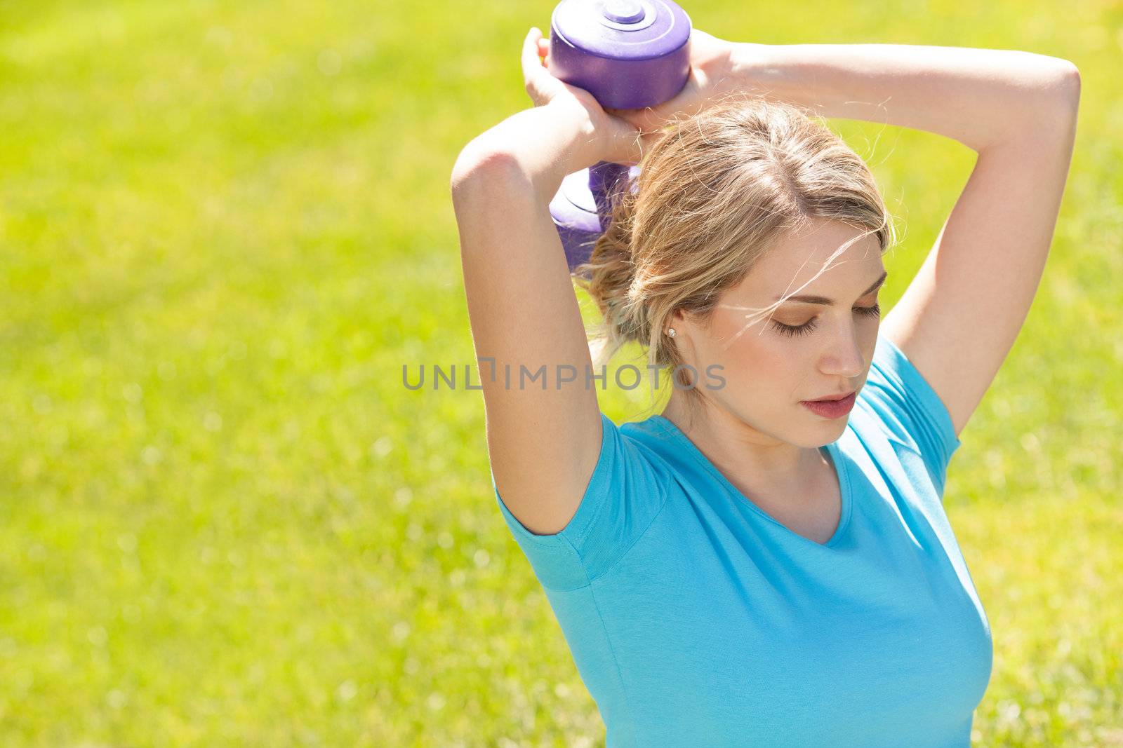 Young sport woman lift weight work out outdoors