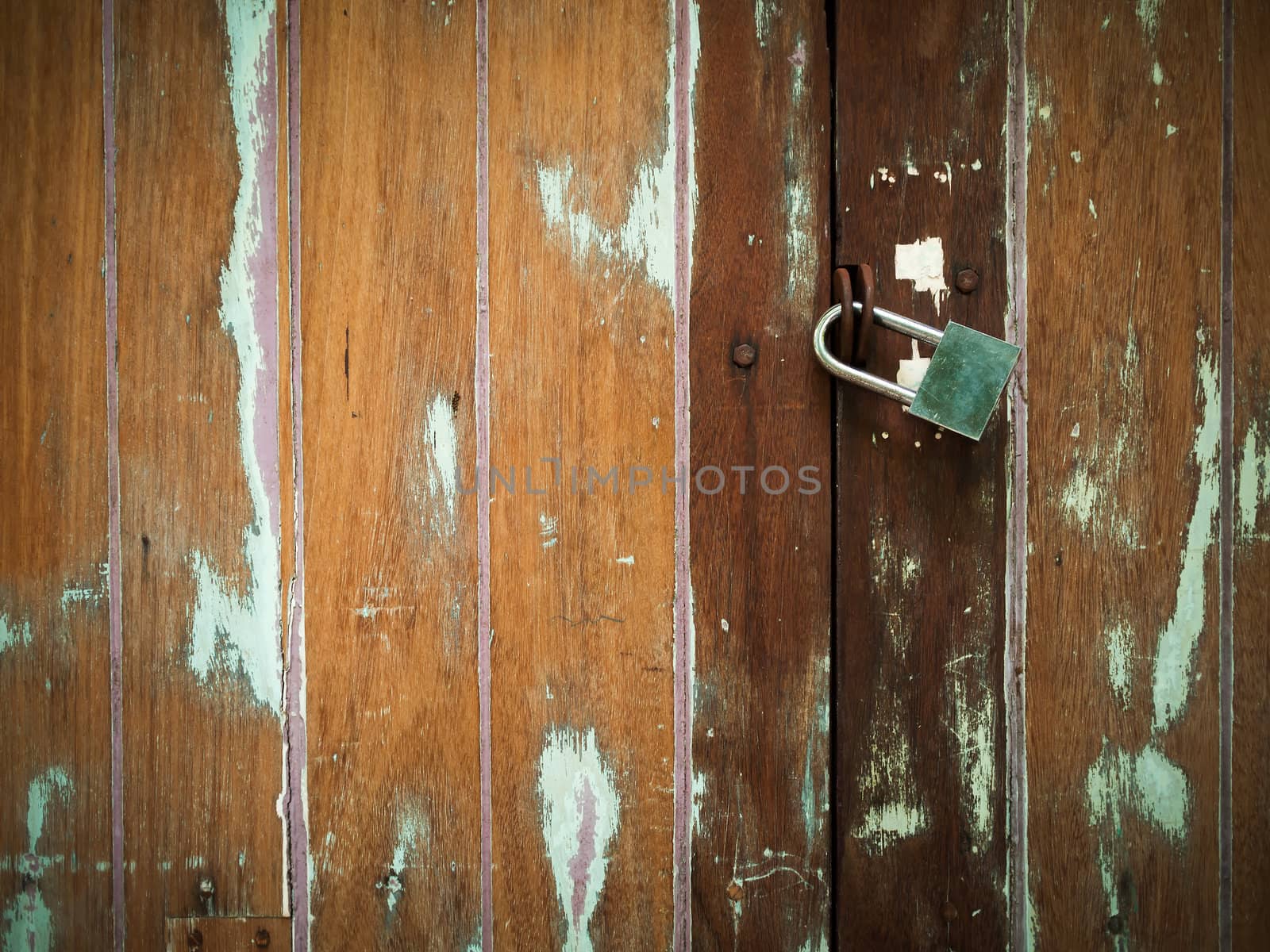 Lock on Plank Cracked Wood Door by nuttakit