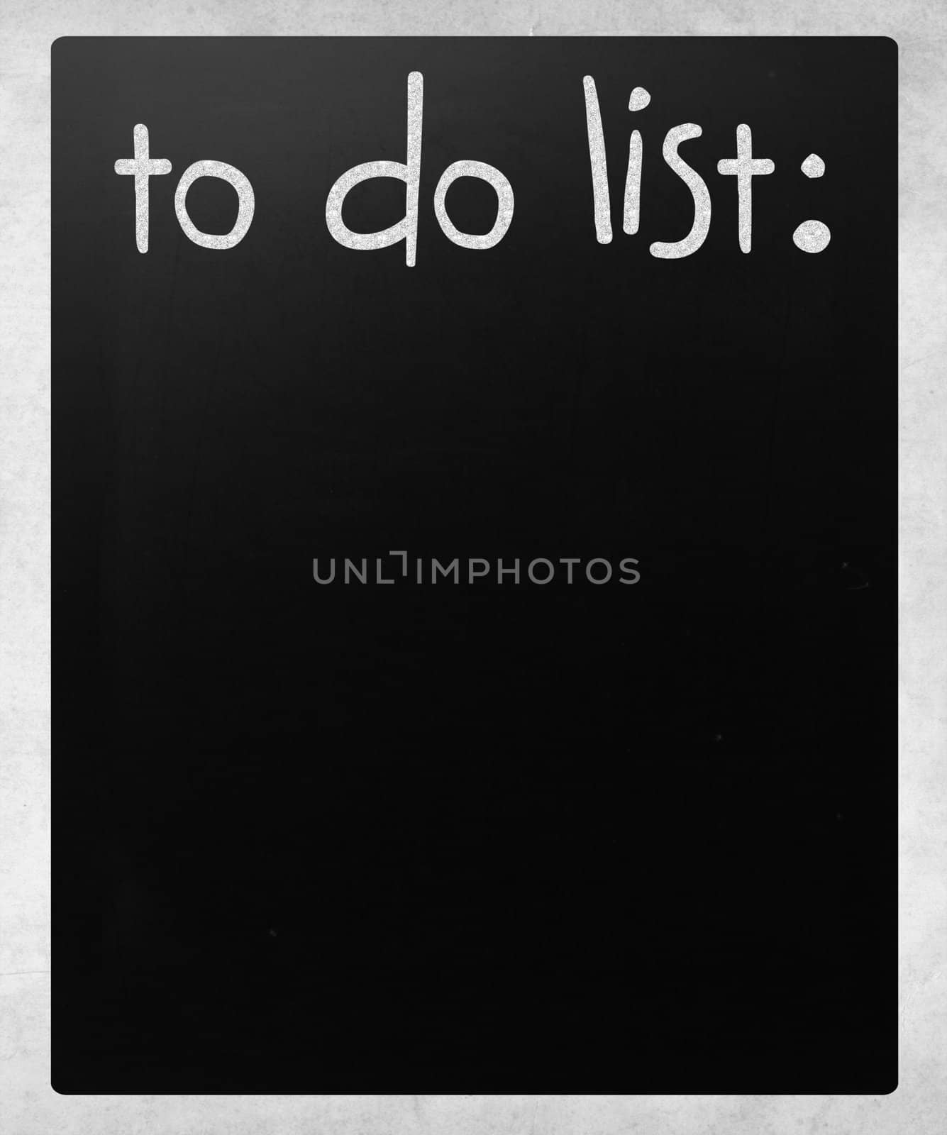 "To do list" handwritten with white chalk on a blackboard by nenov