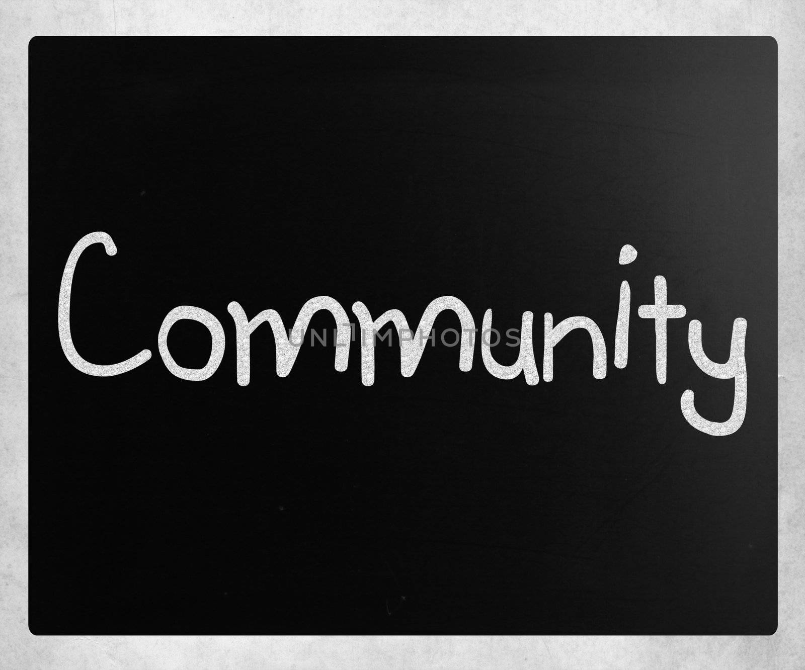 "Community" handwritten with white chalk on a blackboard