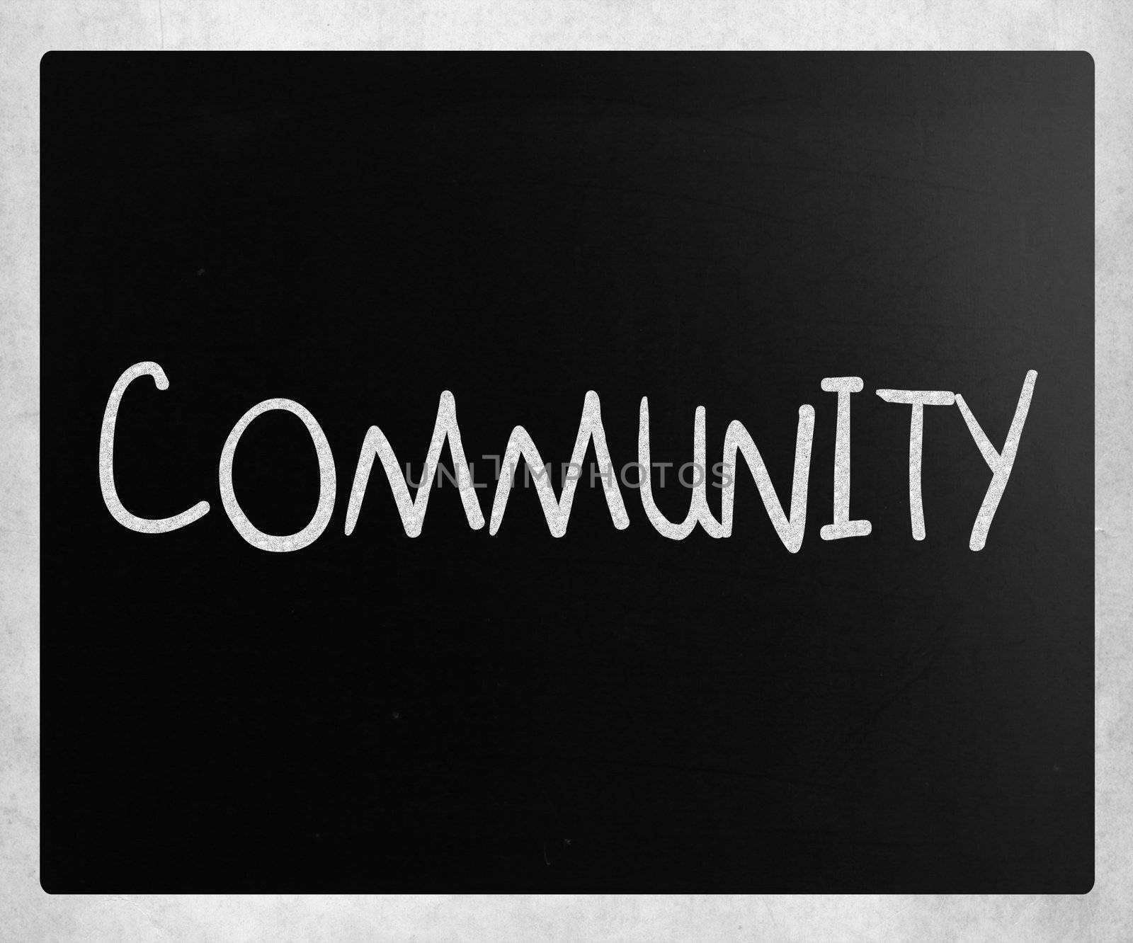 "Community" handwritten with white chalk on a blackboard by nenov