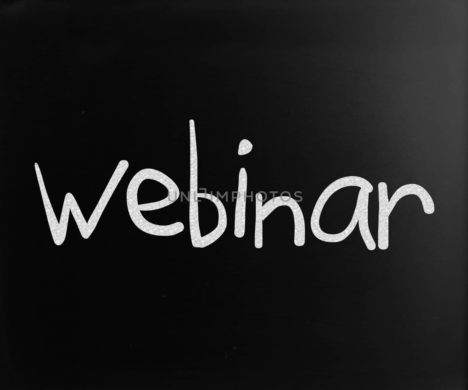 The word "Webinar" handwritten with white chalk on a blackboard