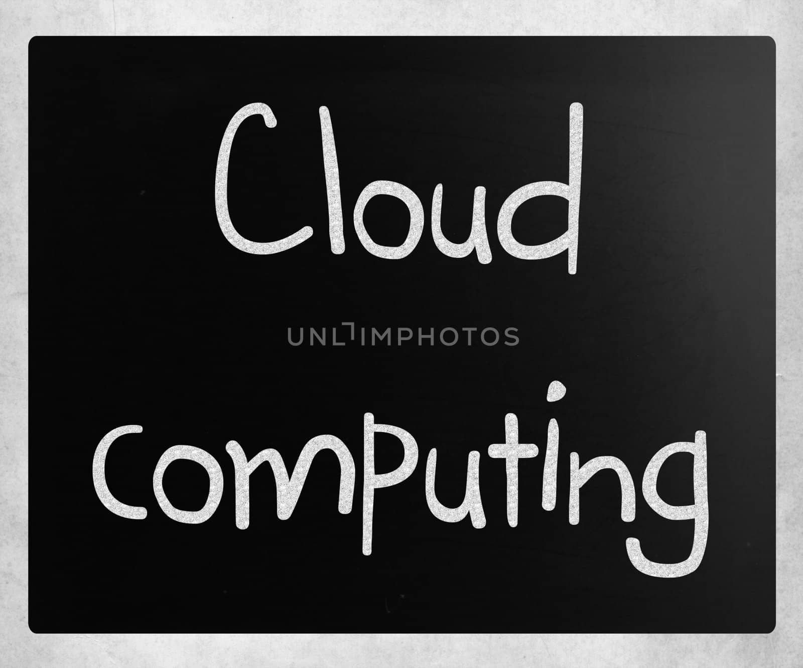 "Cloud computing" handwritten with white chalk on a blackboard