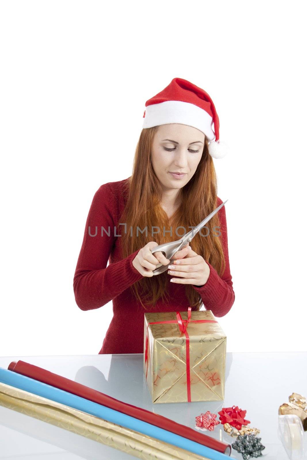 young woman is packing  present for christmas isolated on white