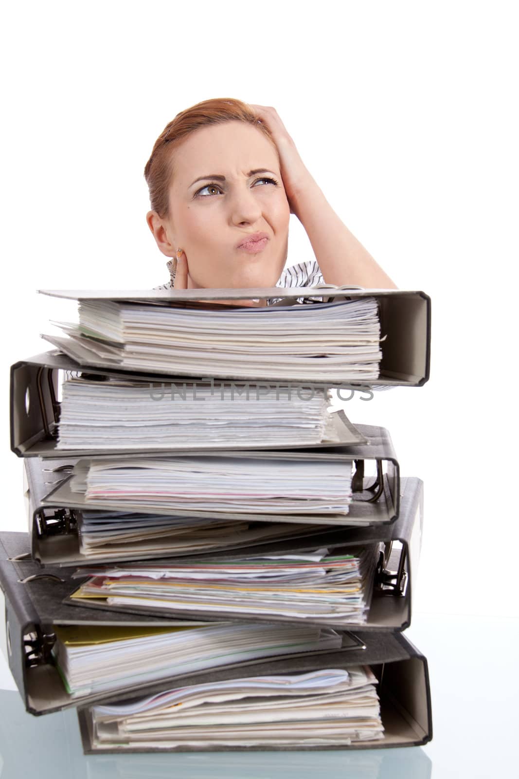 business woman in office looks at unbelievable folder stack isolated on white