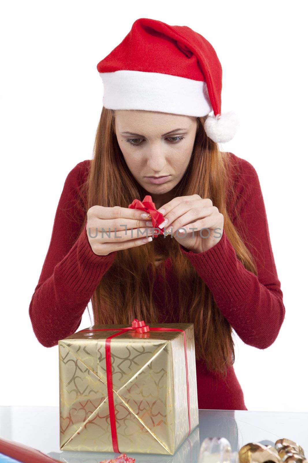 young woman is packing  present for christmas isolated on white