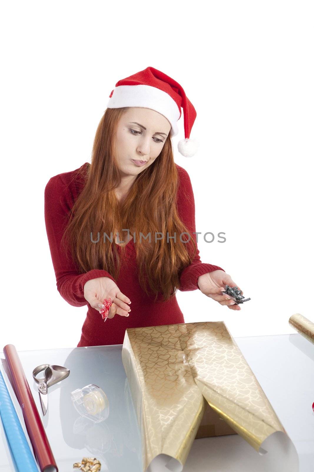 young woman is packing  present for christmas isolated on white