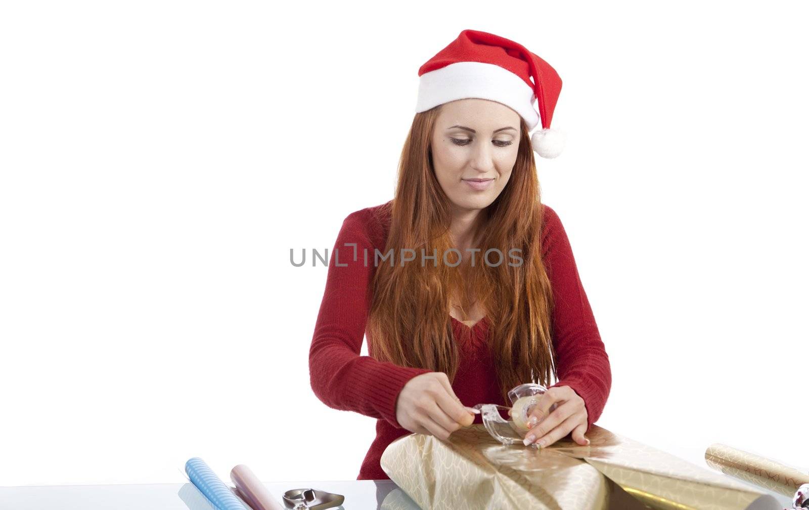 young woman is packing  present for christmas isolated on white