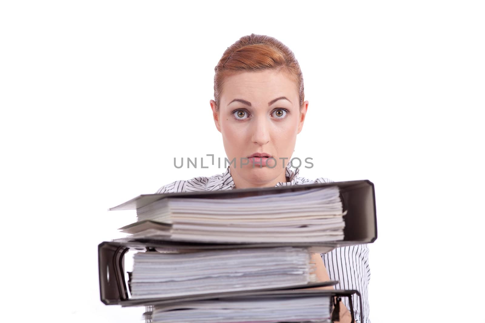 business woman in office looks at unbelievable folder stack isolated on white