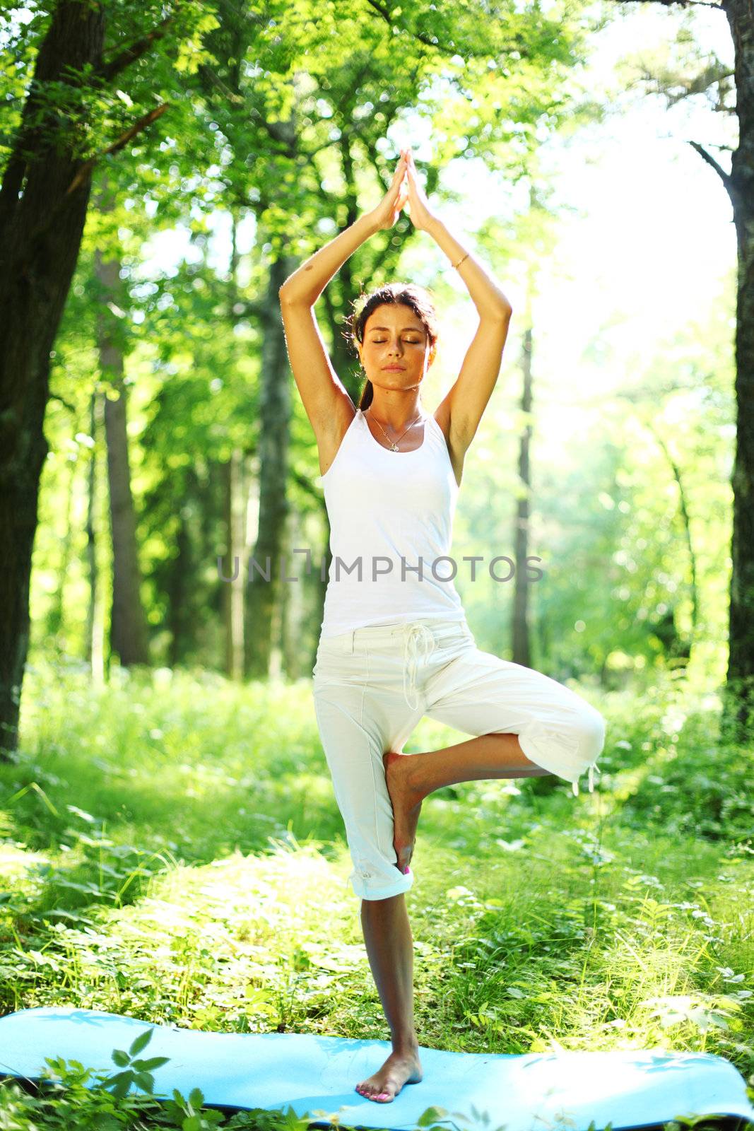 yoga woman on green grass in forest