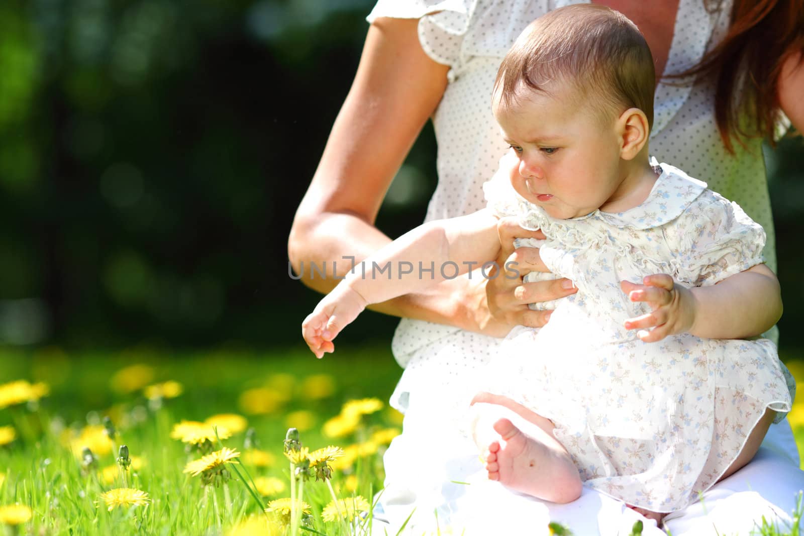 Happy mother and daughter on the green grass