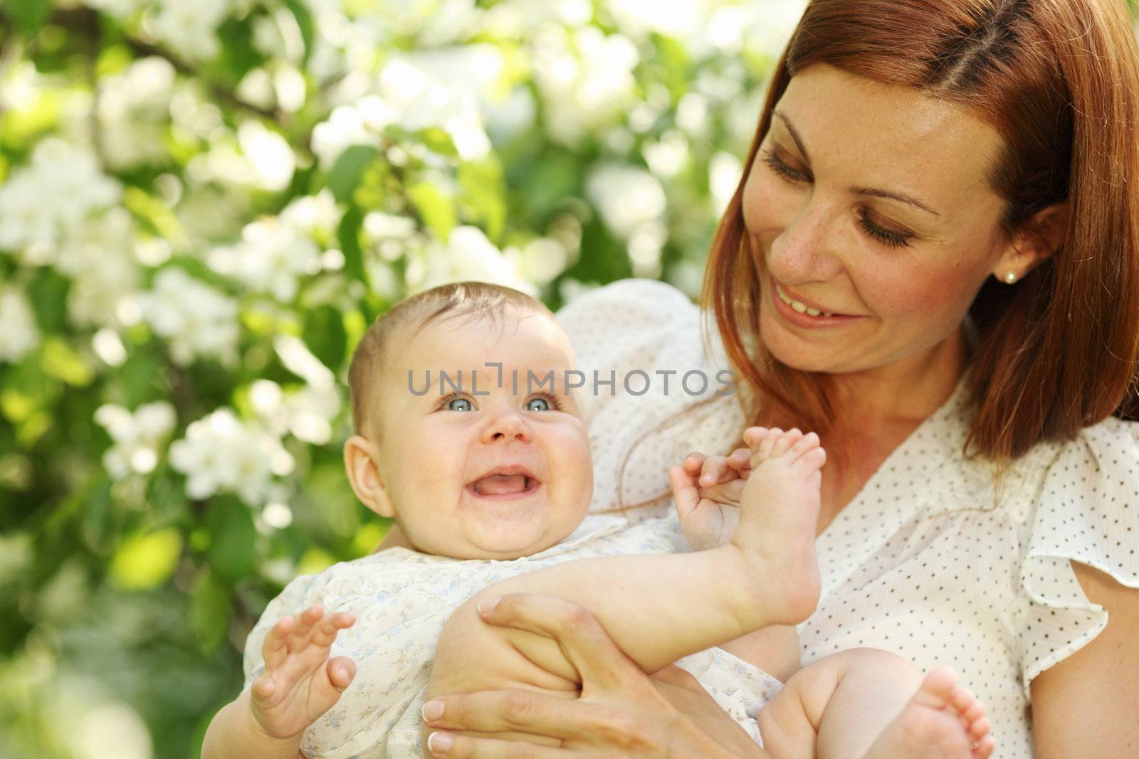 Mother and daughter close up portrait on flower background