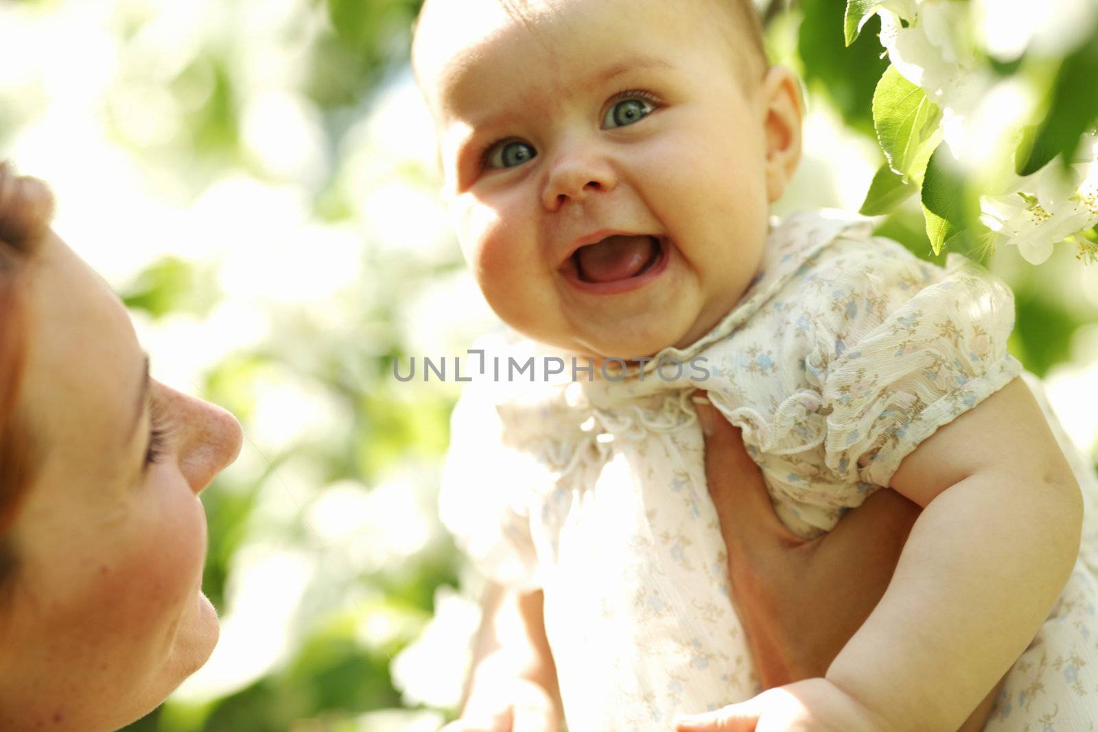 Mother and daughter close up portrait on flower background