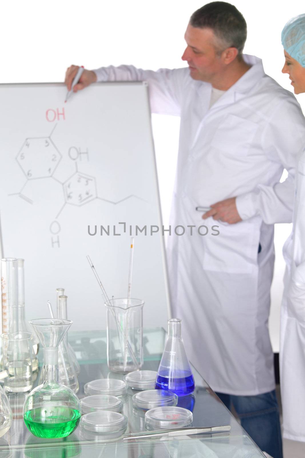  researchers holding a secret green chemical substance