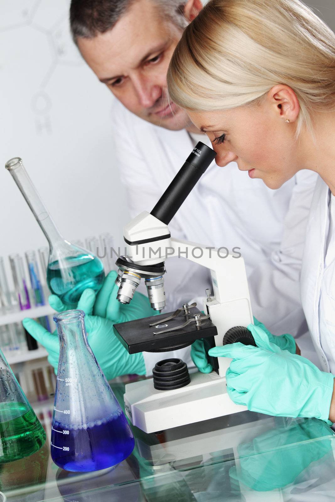 two scientist in chemical lab conducting experiments