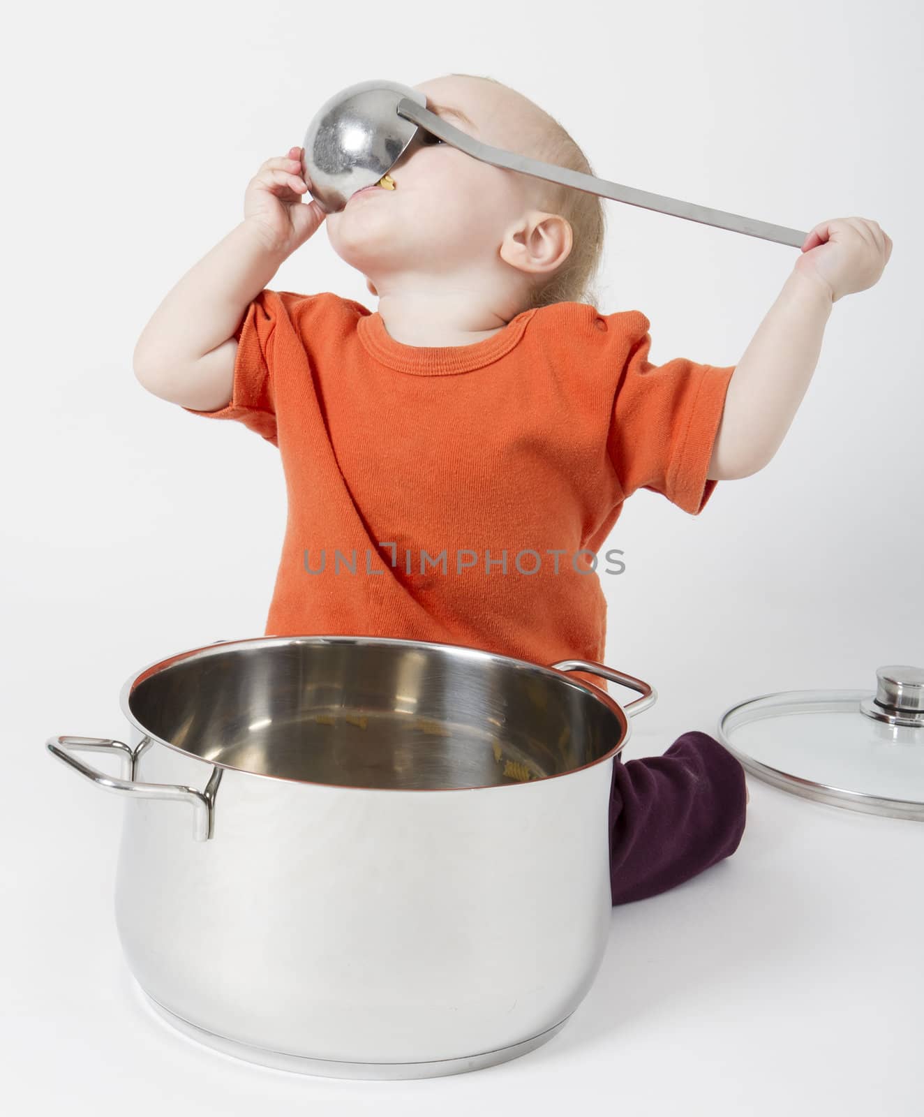 baby with big cooking pot on grey background