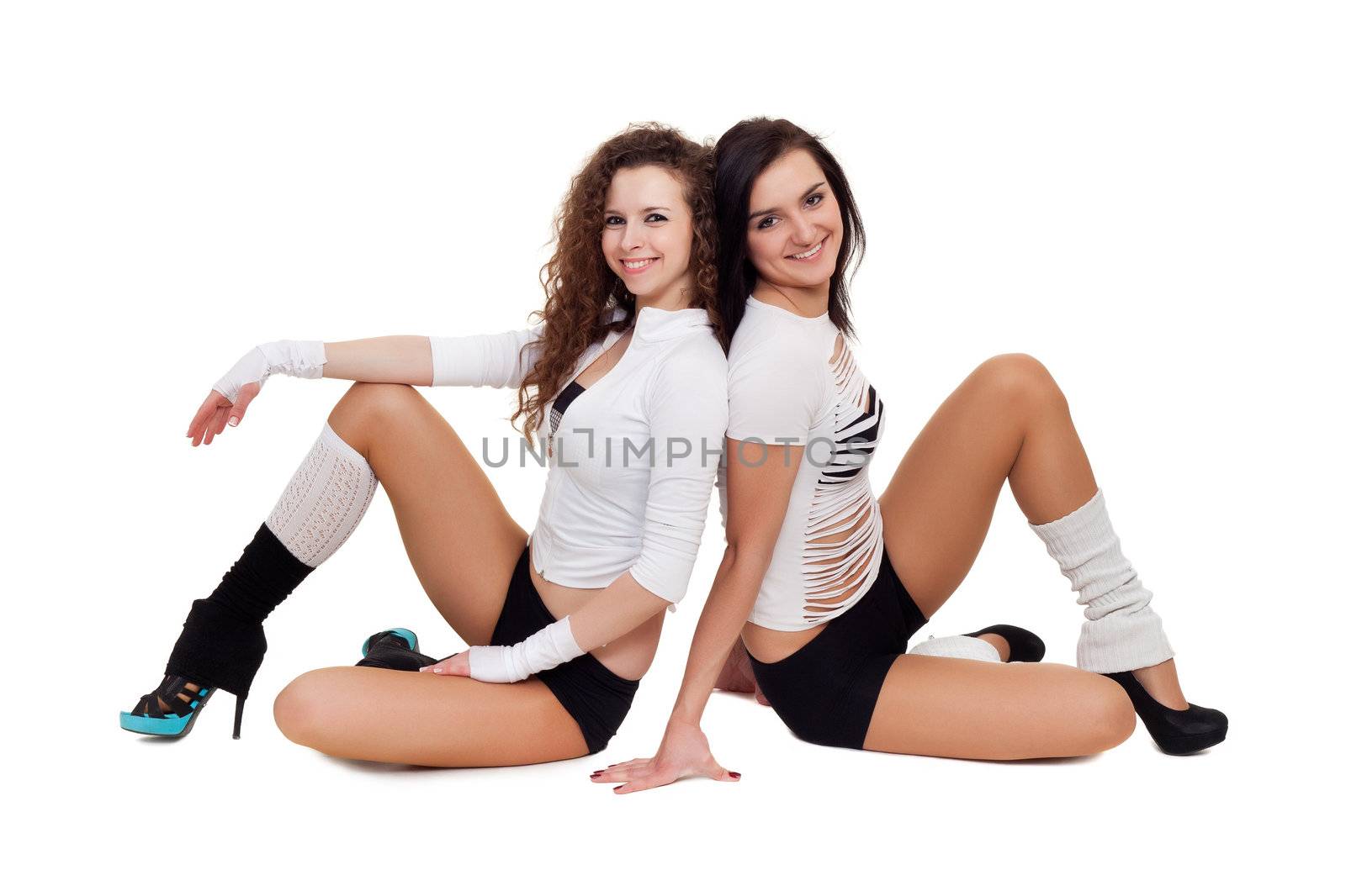 Two sexy dancers posing for photo sitting on the floor