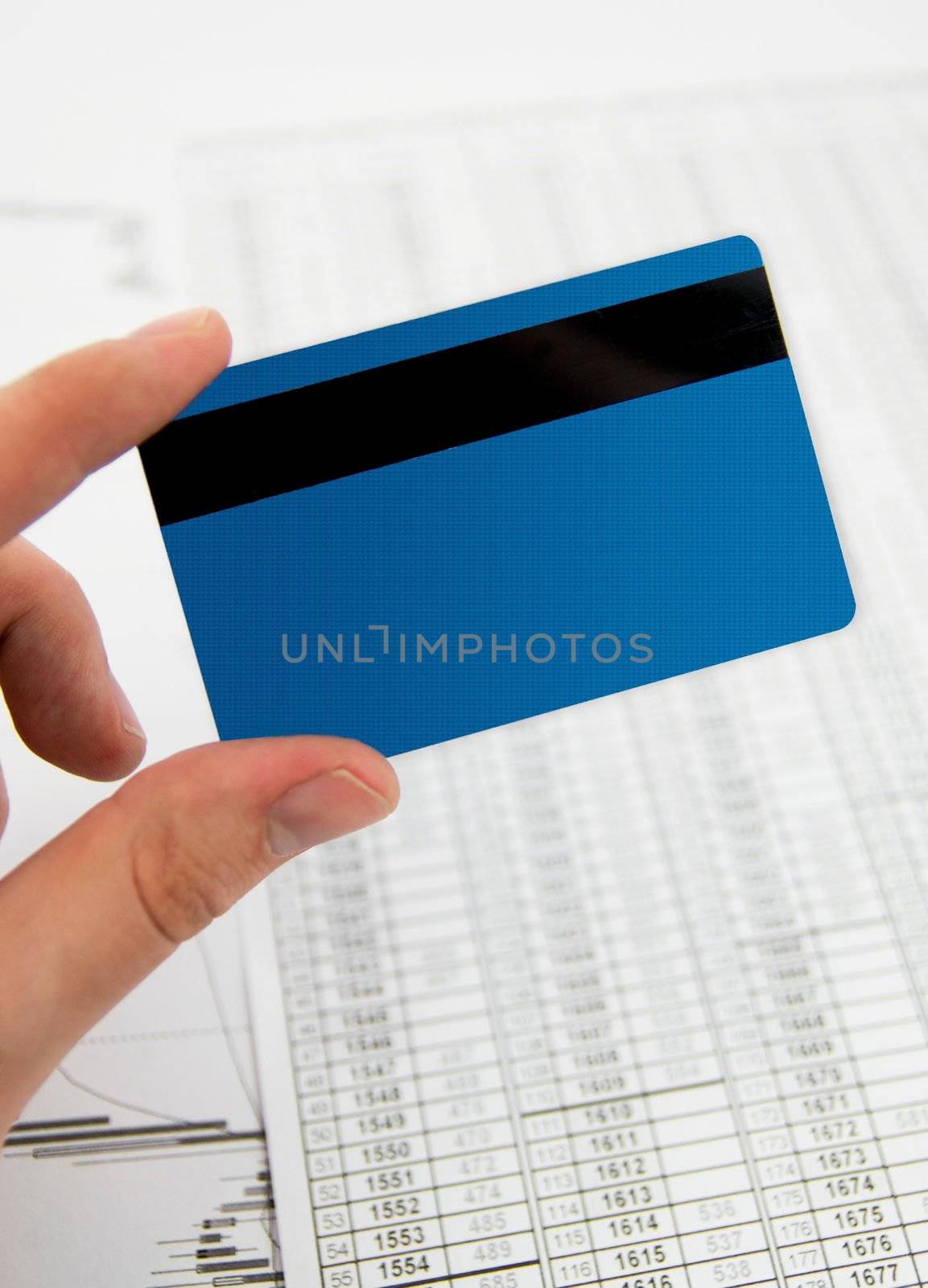 Credit, debit card in hand on business background