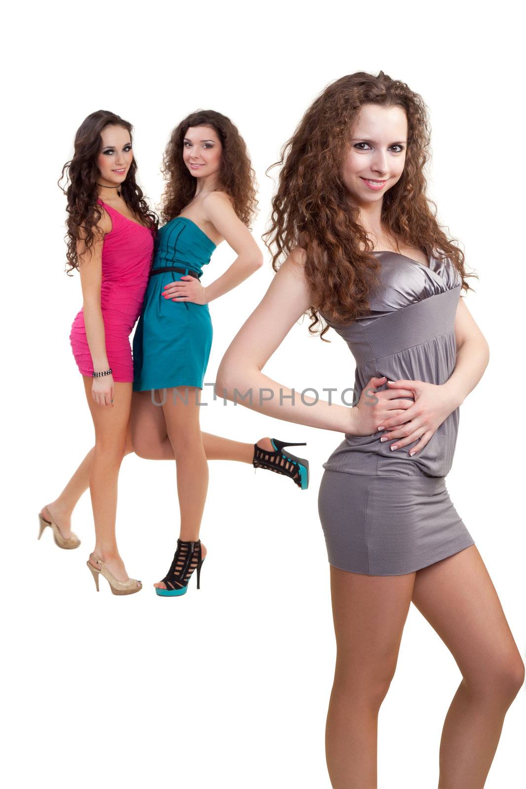 Image of three beauties in colorful dresses posing for photo