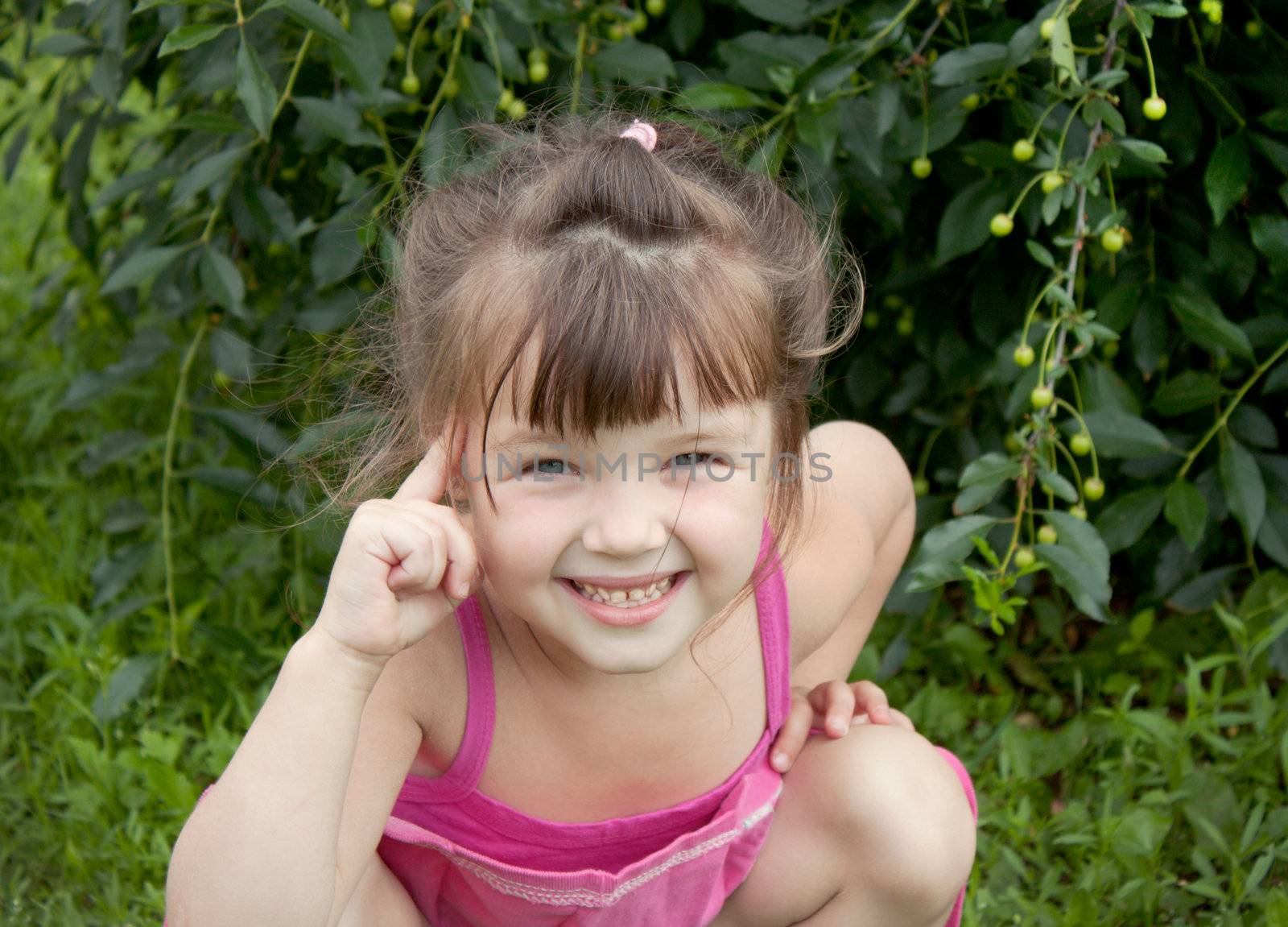 The little girl playfully twists his finger to his temple