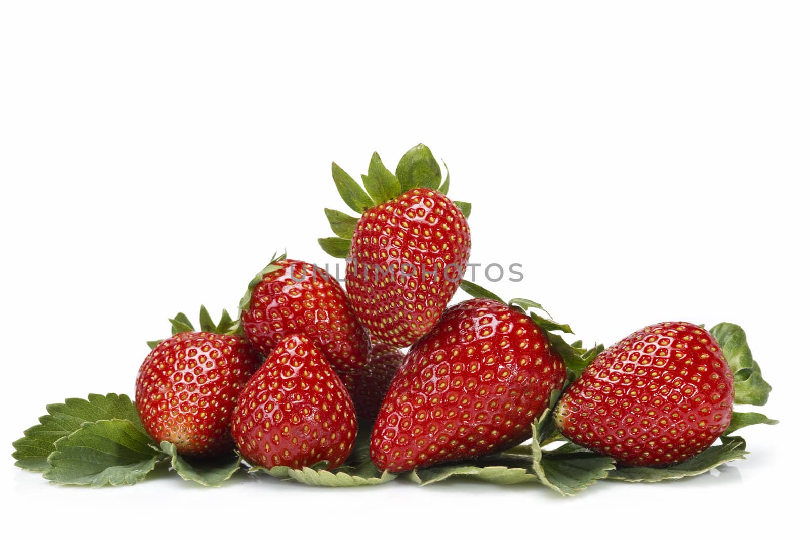 Strawberries with their leaves isolated on a white background