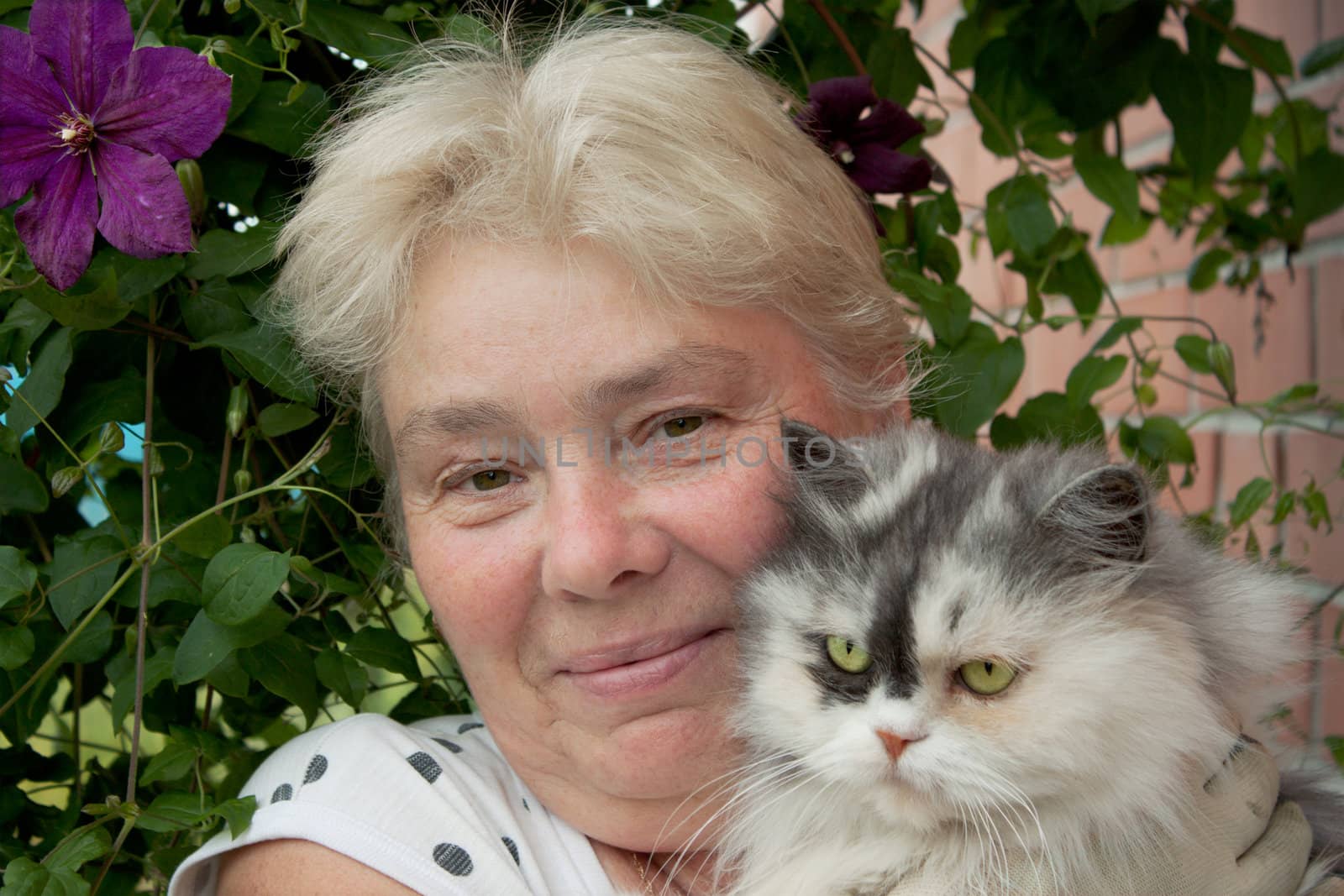 A housewife and her pet cat in the garden