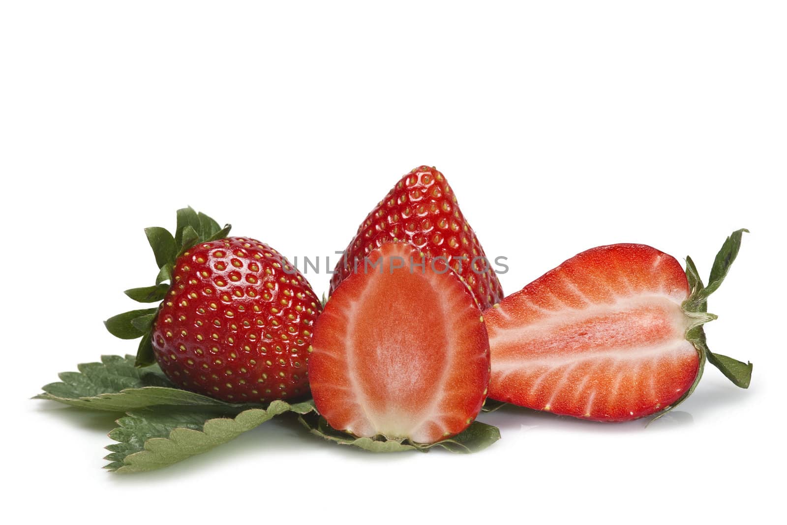 Strawberries with their leaves isolated on a white background