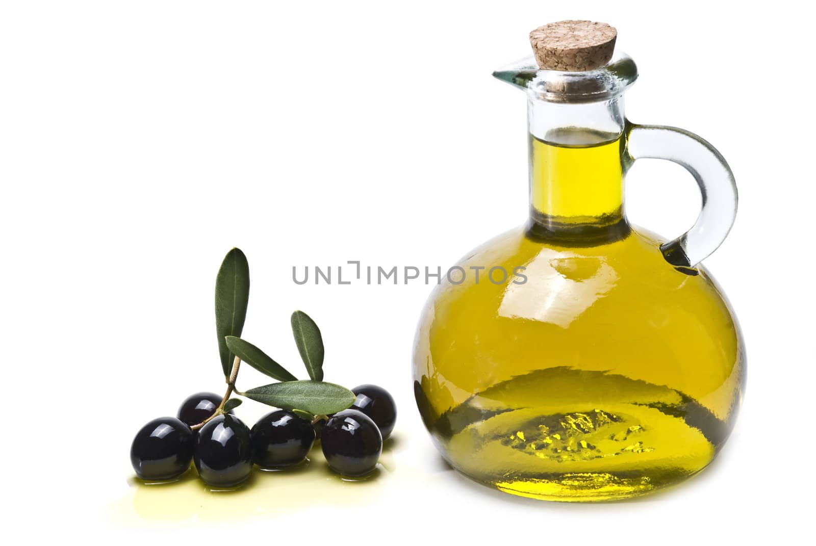 A jar with olive oil and some black olives isolated over a white background.
