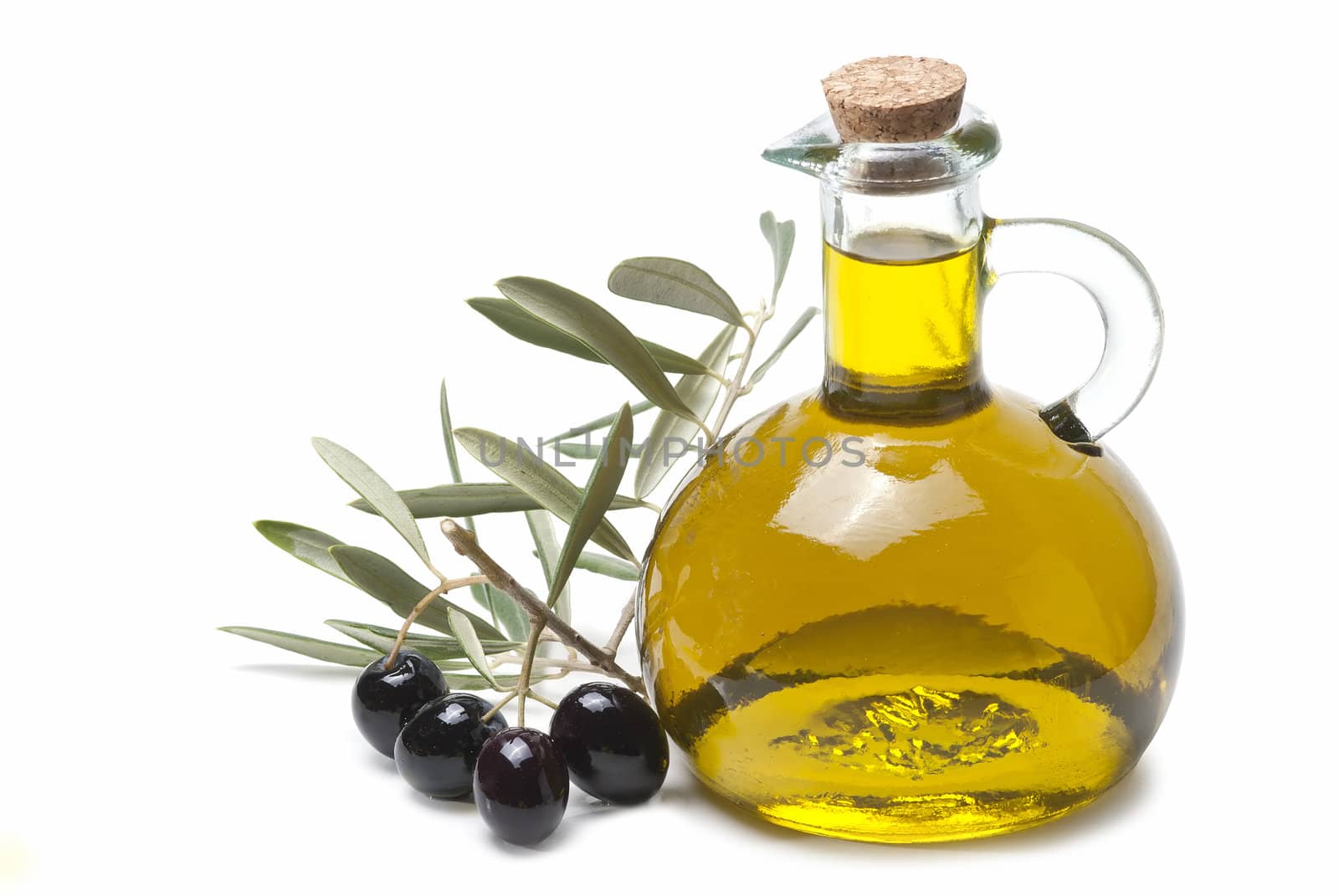 A jar with olive oil and some black olives isolated over a white background.
