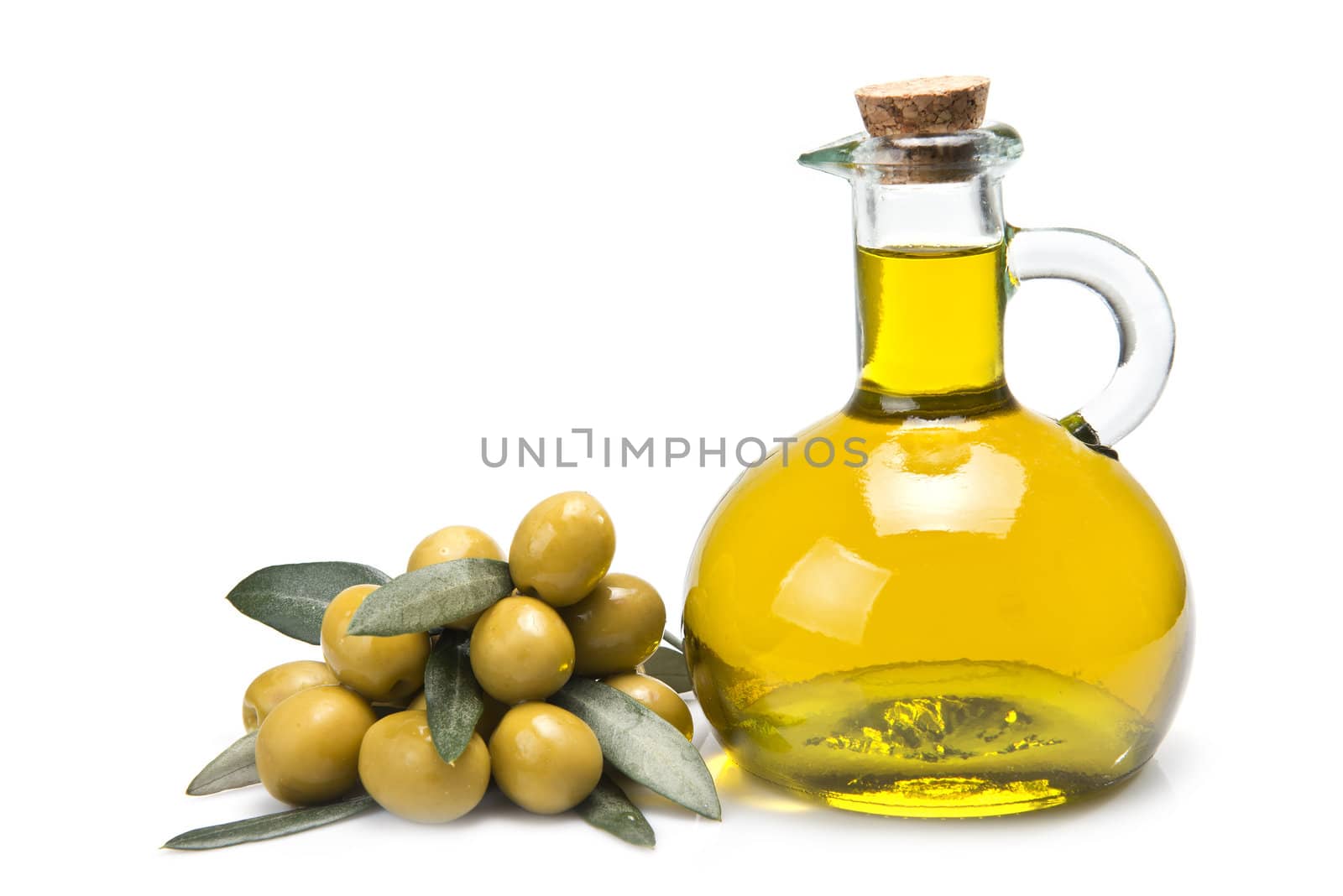 A jar with olive oil and some green olives isolated over a white background.