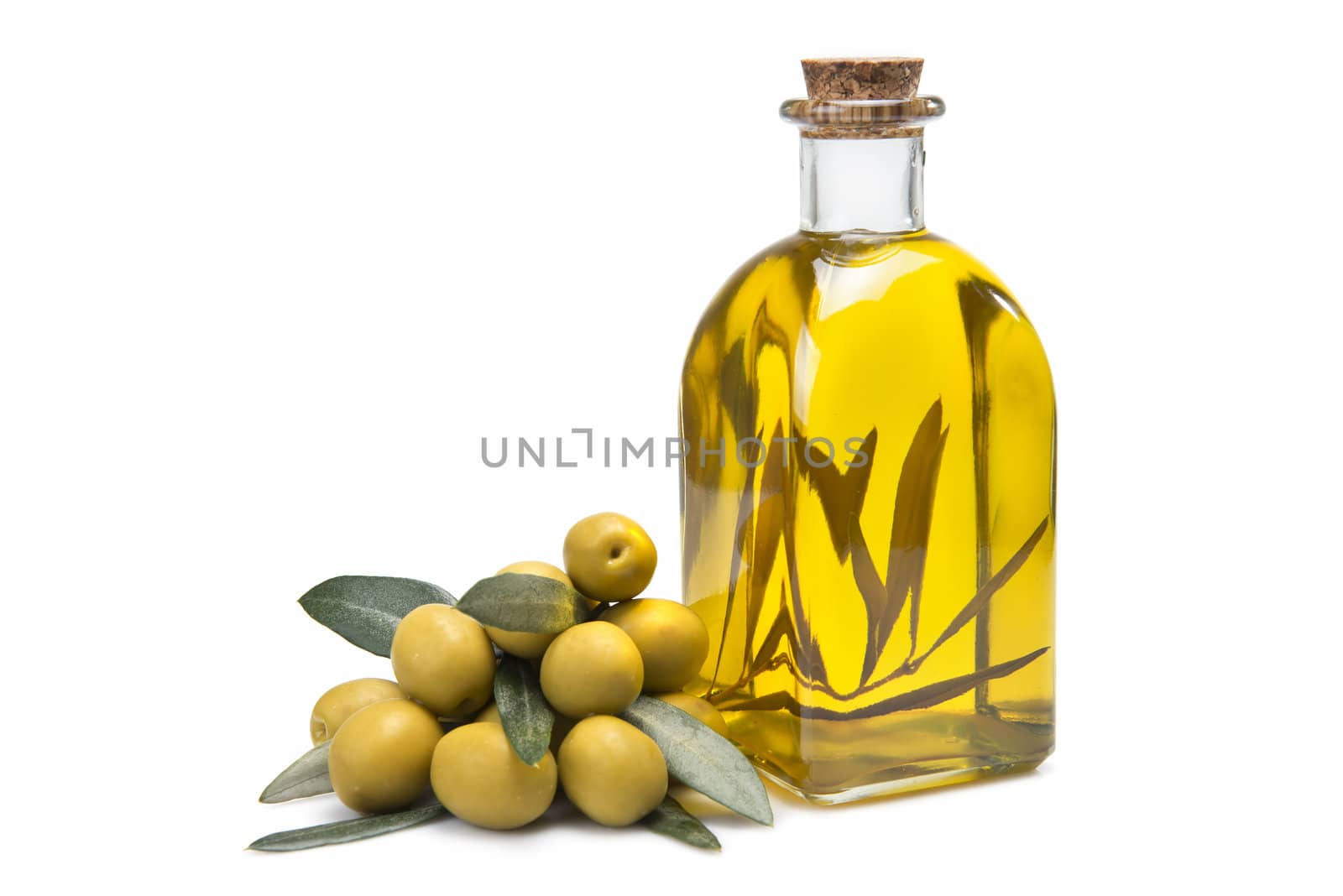 A jar with olive oil and some green olives isolated over a white background.