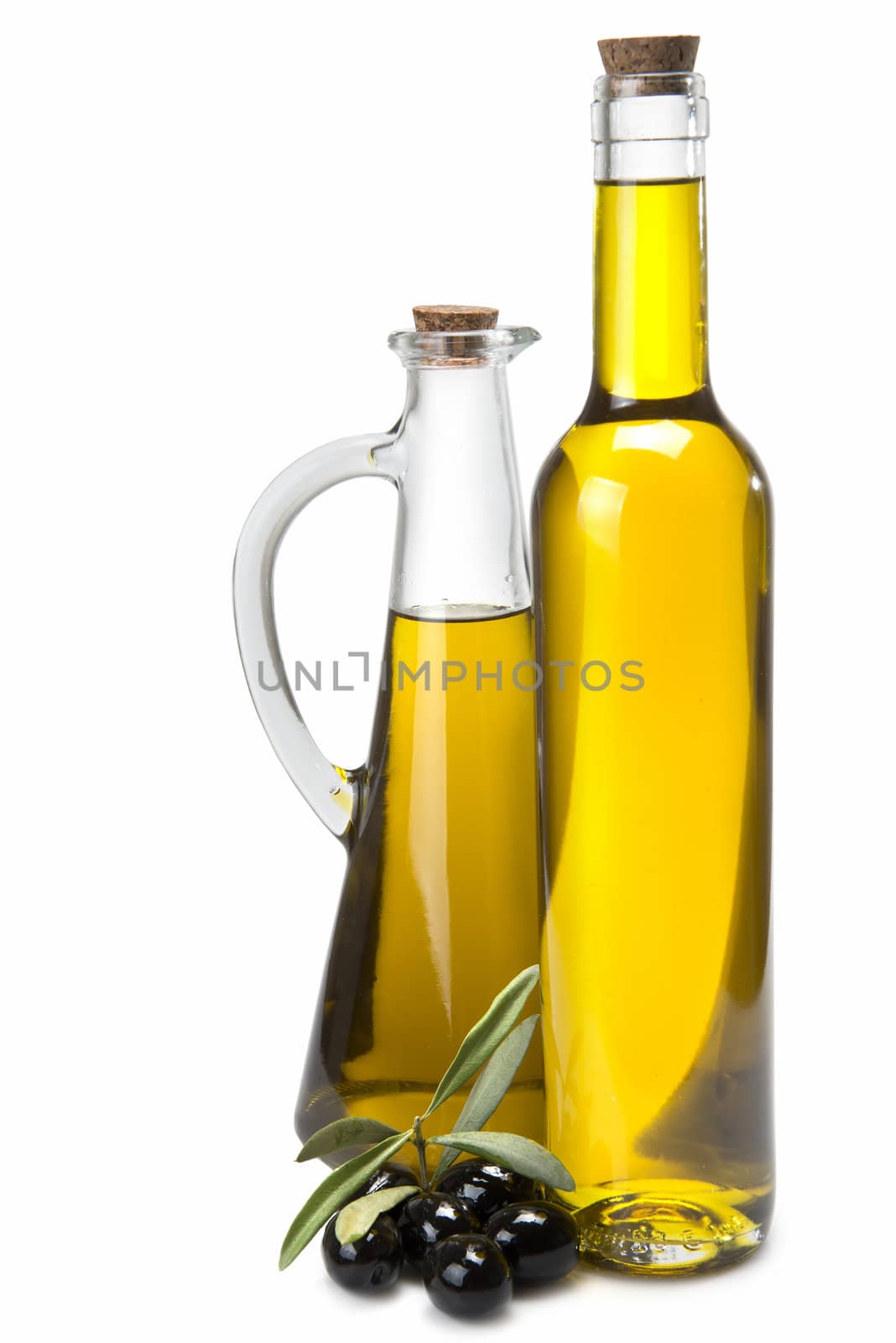 Jars with olive oil and some olives isolated over a white background.