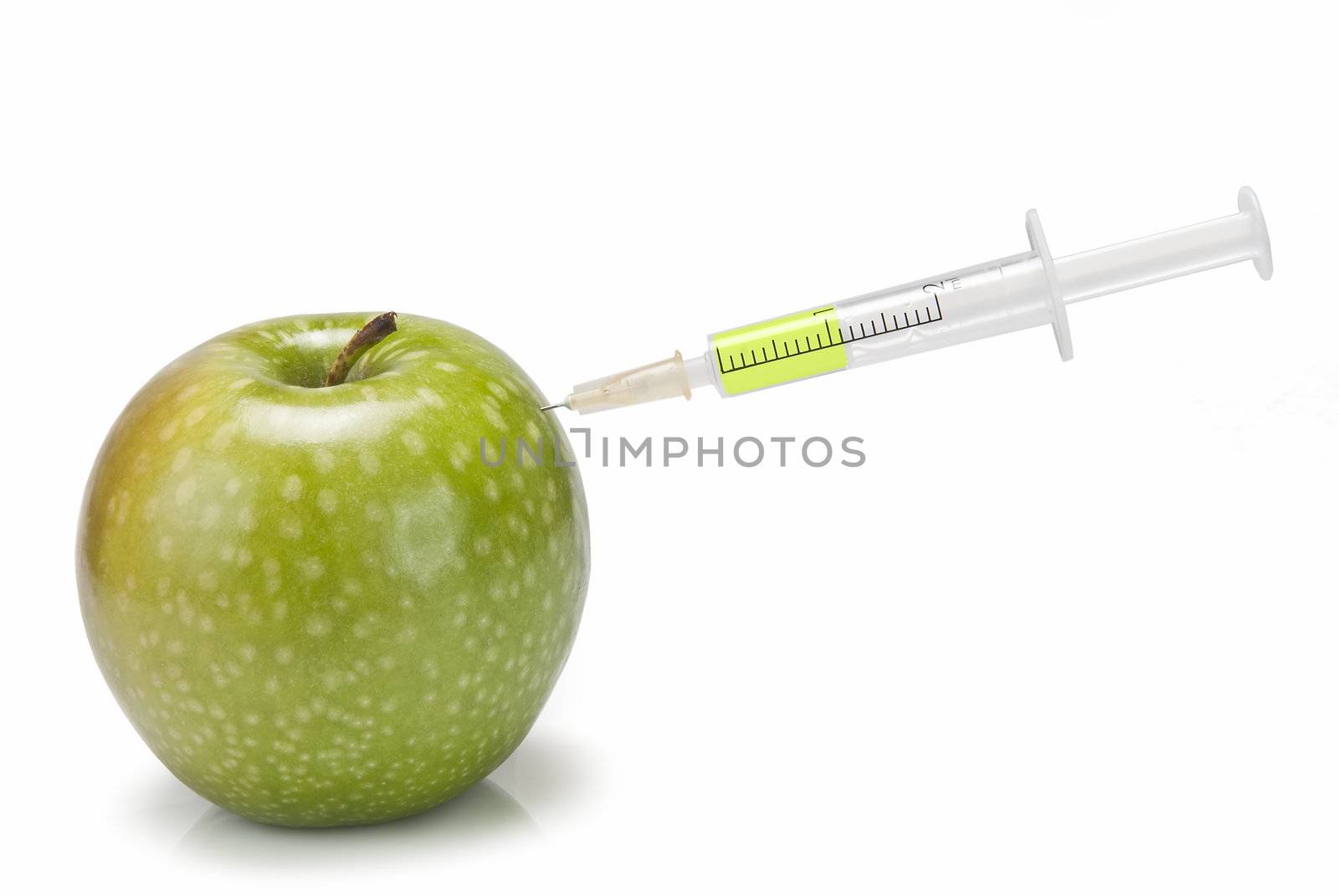 Syringe inserted in  an apple. by angelsimon