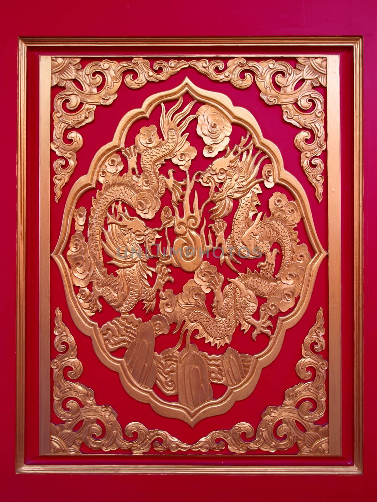  Golden Chinese Dragon in red wall ,temple in thailand