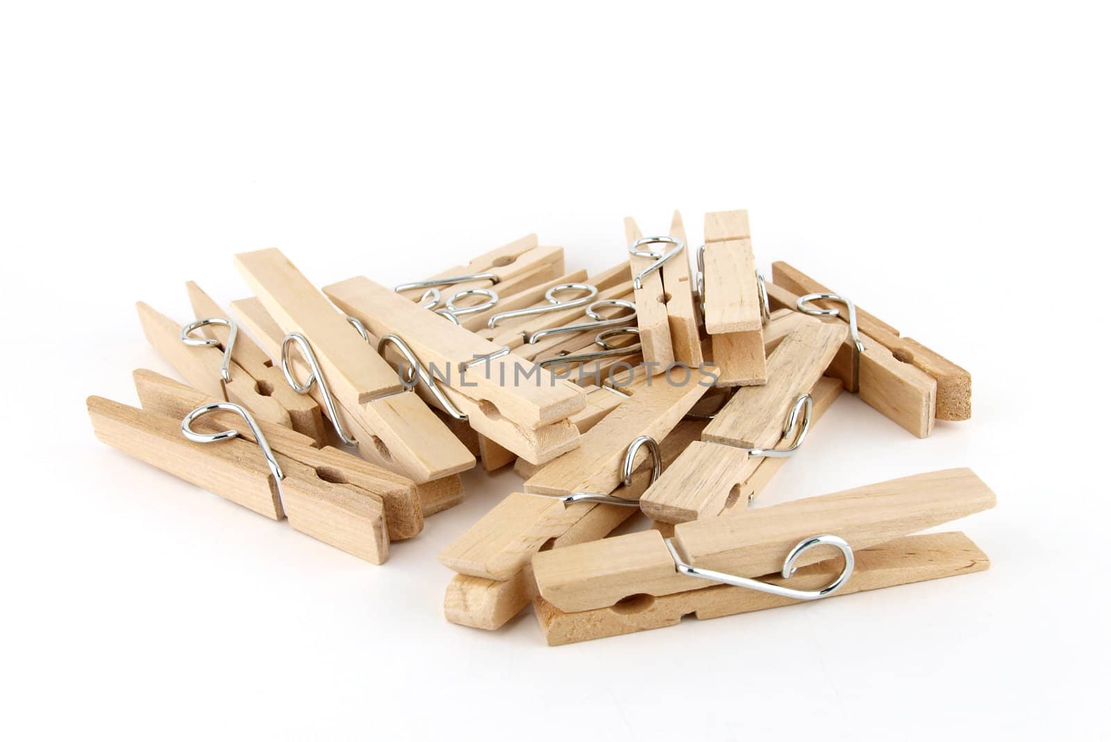 Heap of brown wooden cloth pin isolated on white  