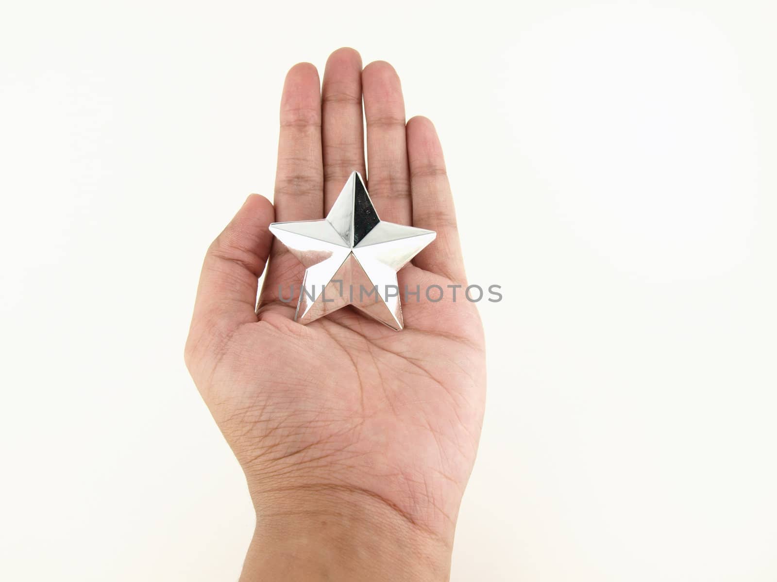 Silver star in hands on white background    