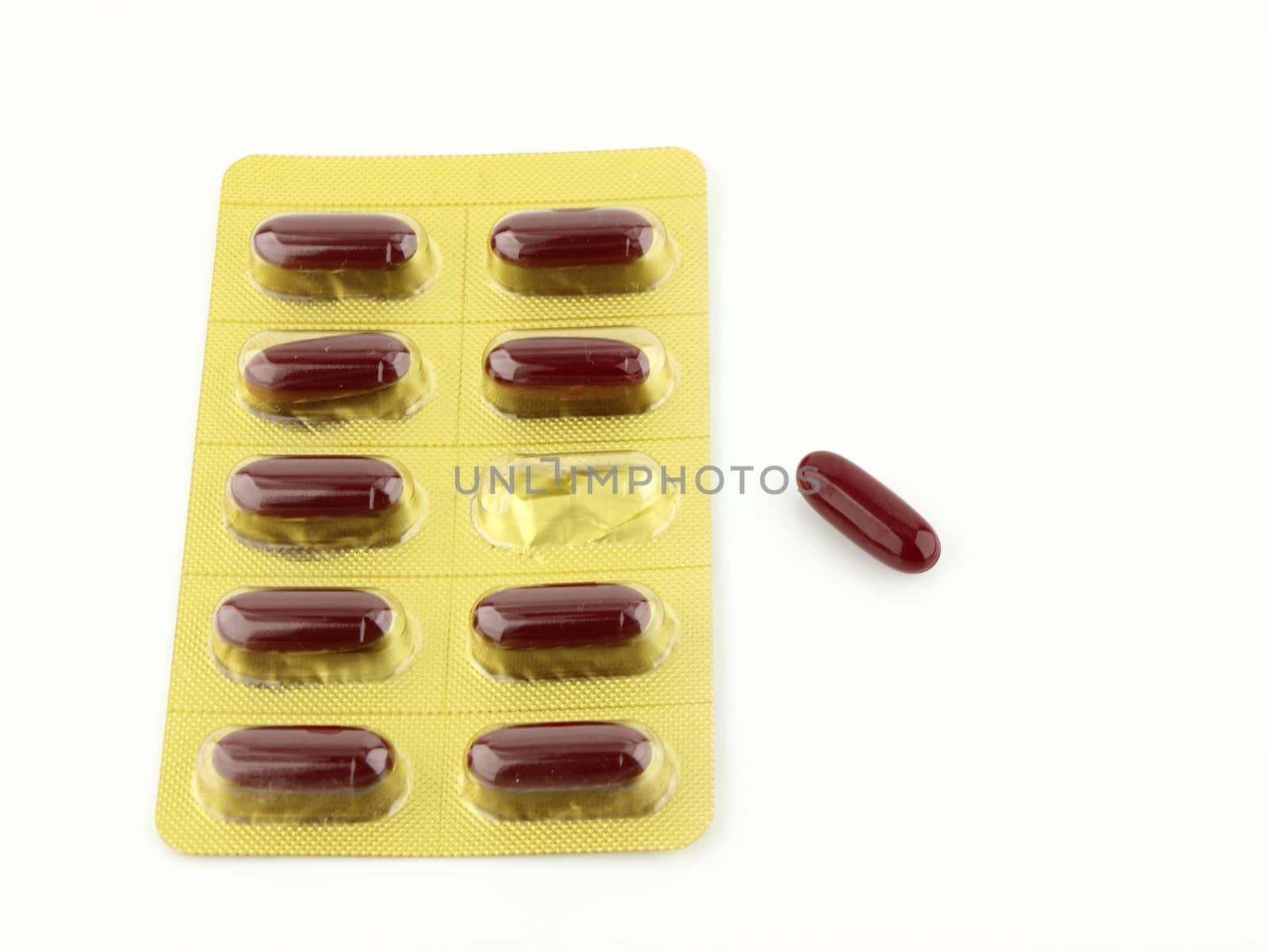 Red capsules packed in blister isolated on white  