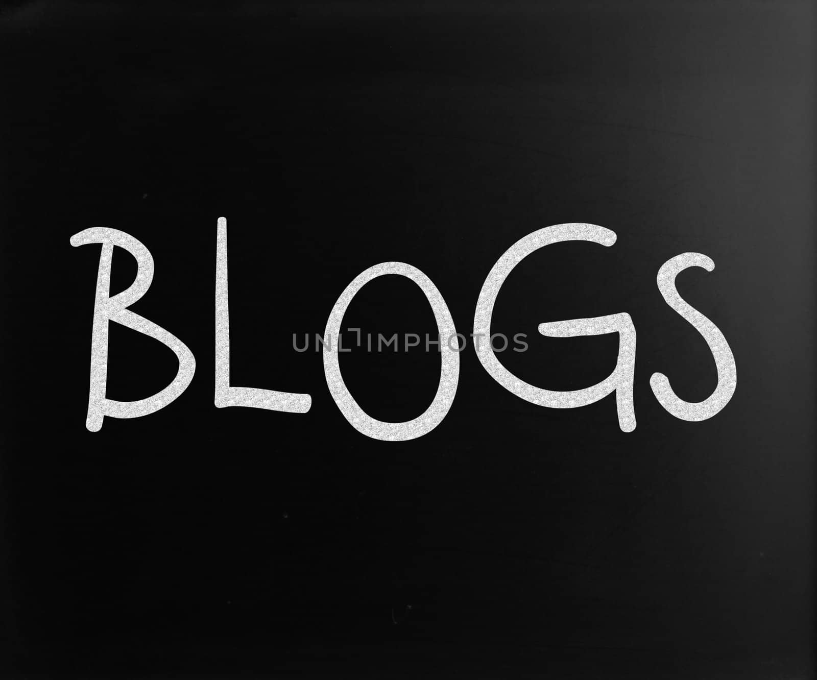 "Blogs" handwritten with white chalk on a blackboard