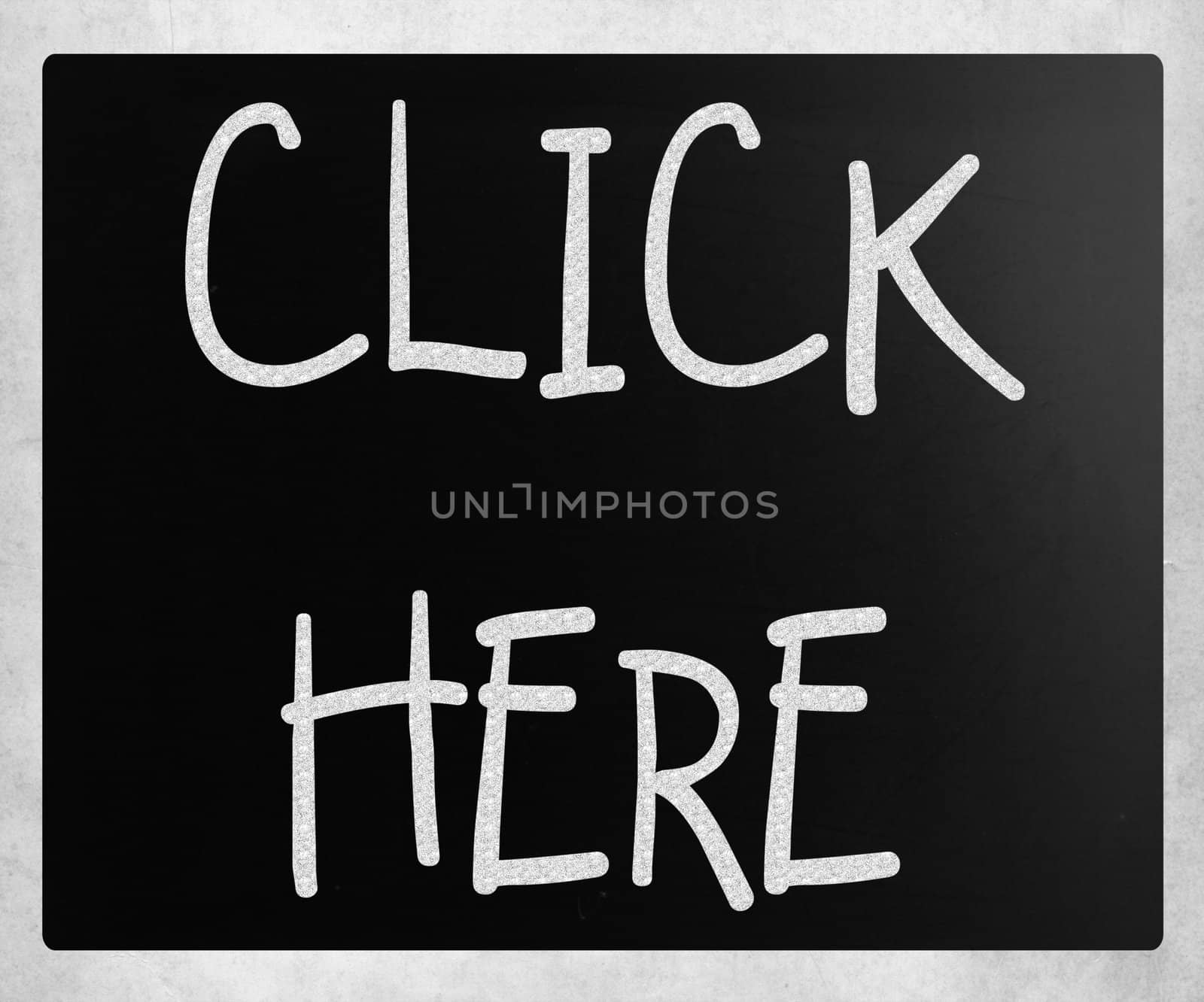 "Click here" handwritten with white chalk on a blackboard by nenov