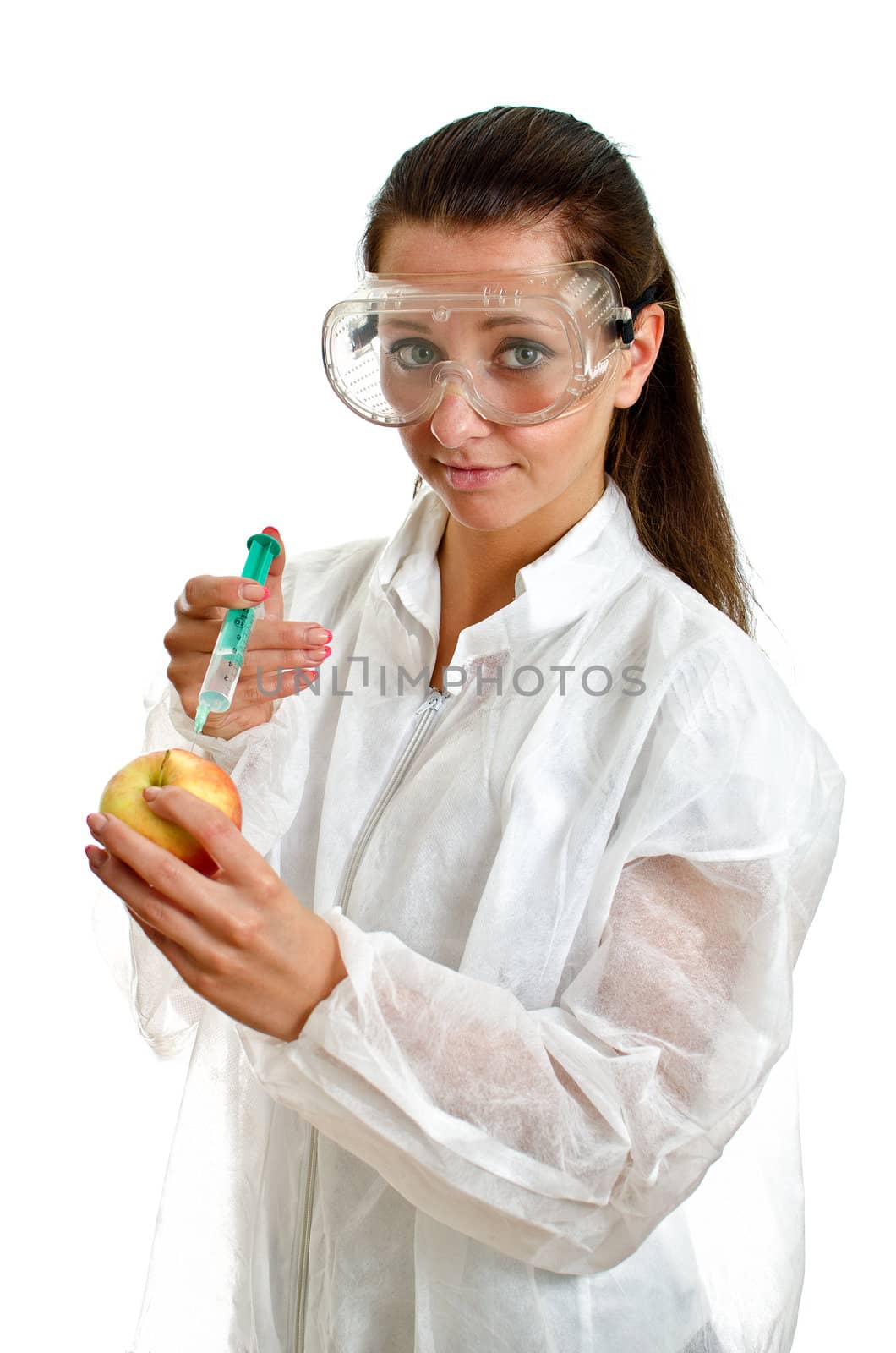 Female scientist in lab coat with syringe and apple. Isolated on white.