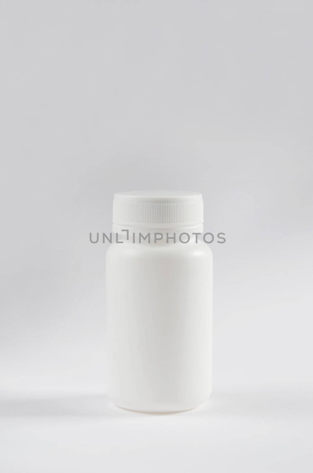 white plastic bottle for drugs on white .