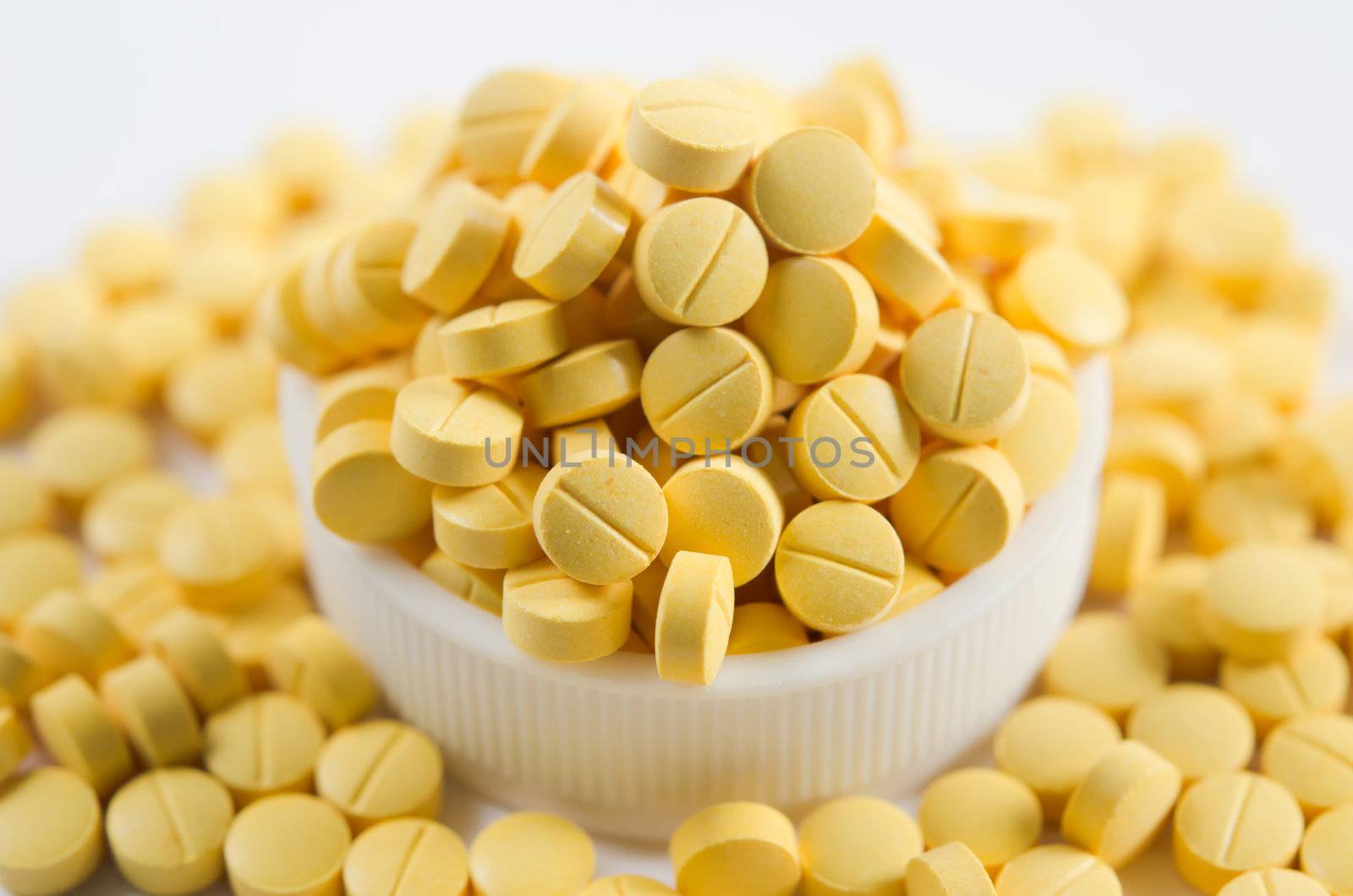 Many yellow medicine  on the white background